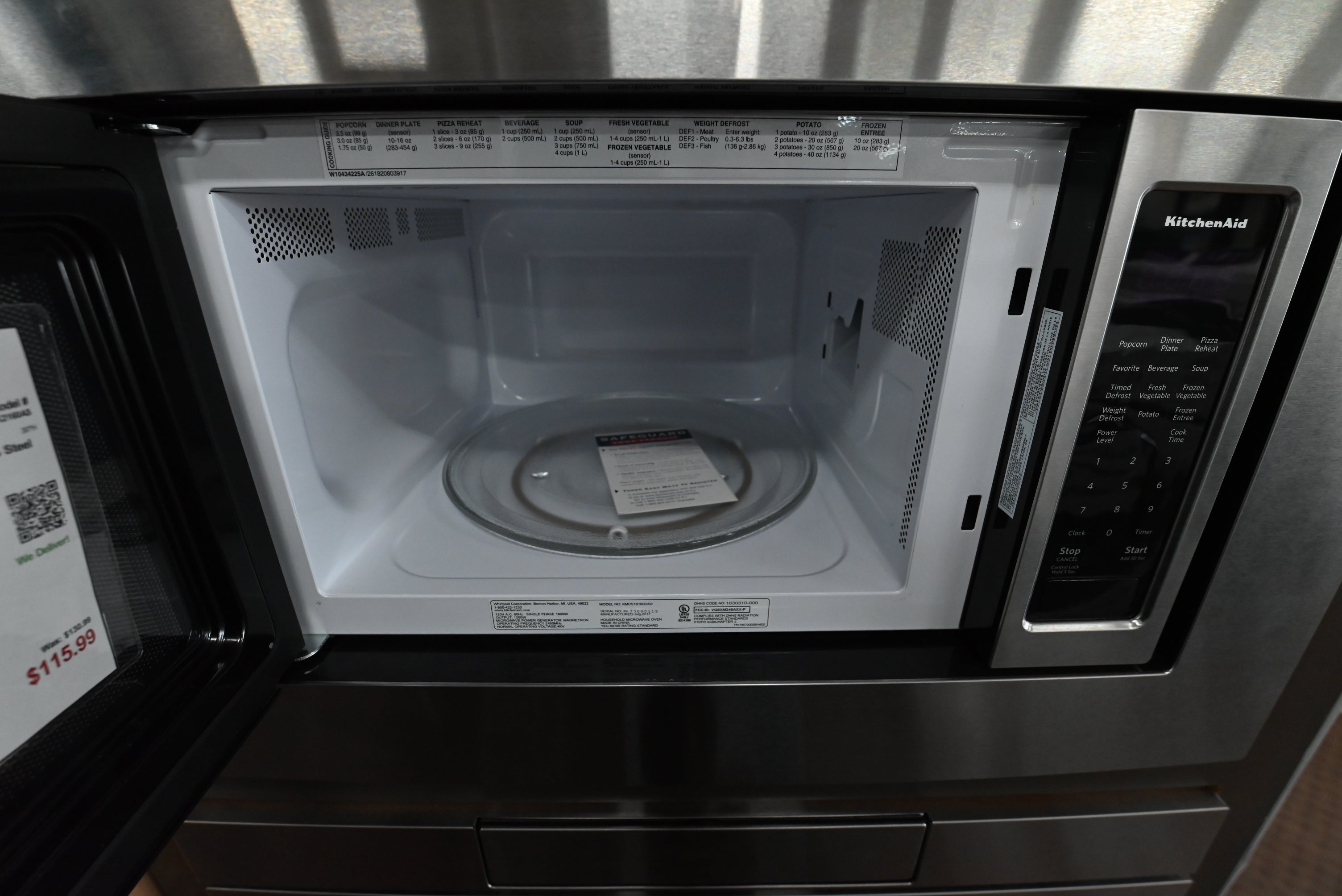 Premium 1200 watt KitchenAid microwave door open showing recessed glass turntable interior
