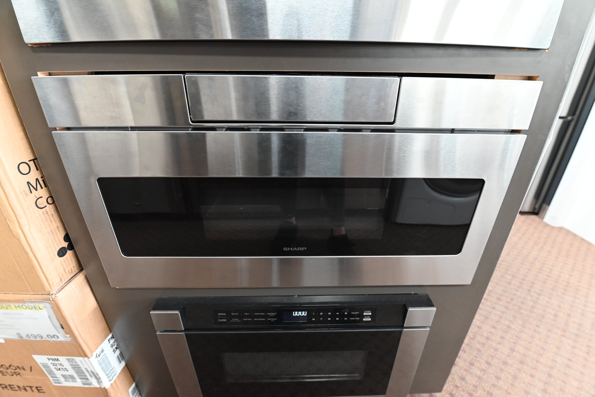 Sharp SMD3070AS 30 inch built in microwave drawer in stainless steel with a black glass front installed under a kitchen counter