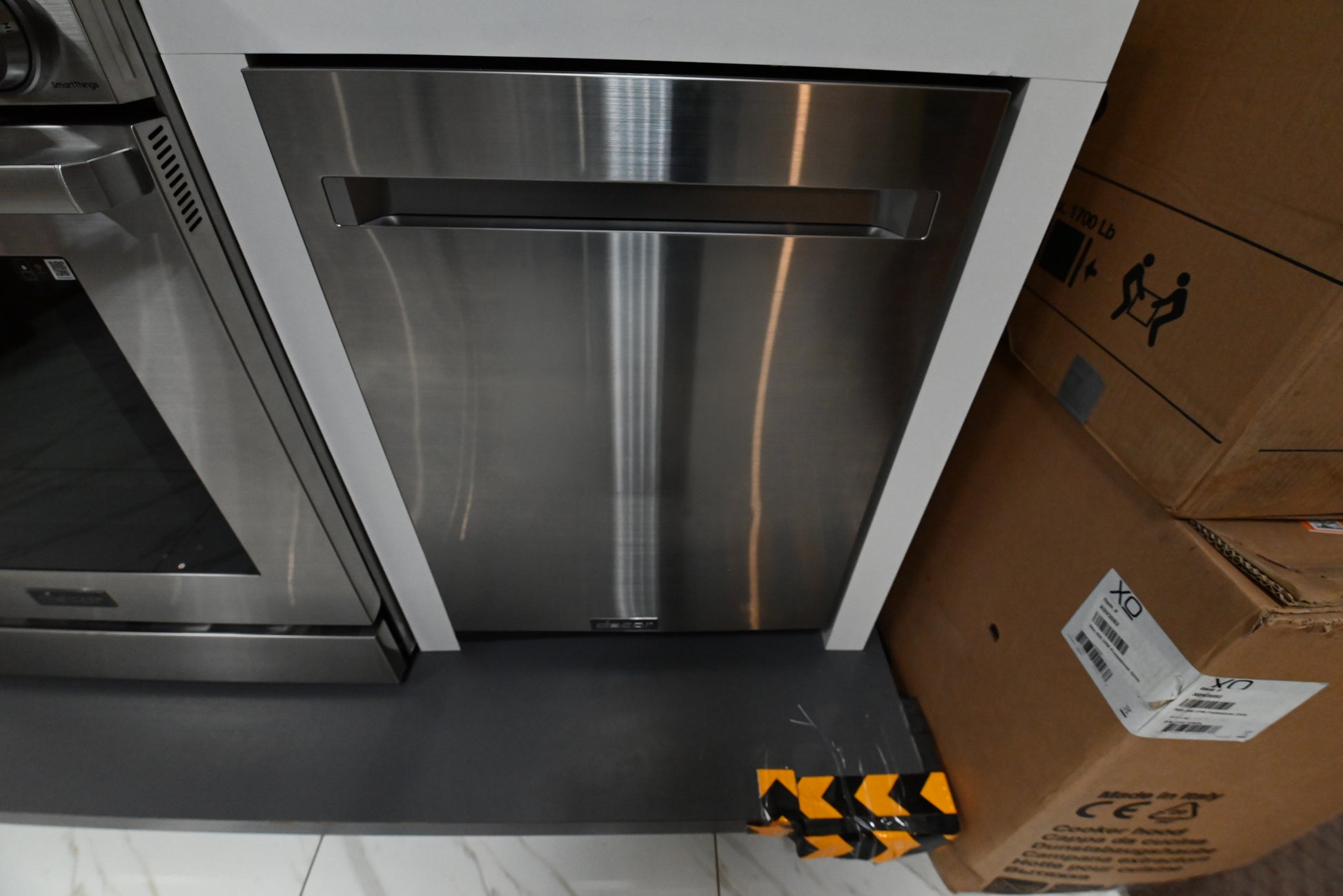 Dacor DDW24G9000APDA 24 inch integrated dishwasher front view with silver stainless steel panel kit