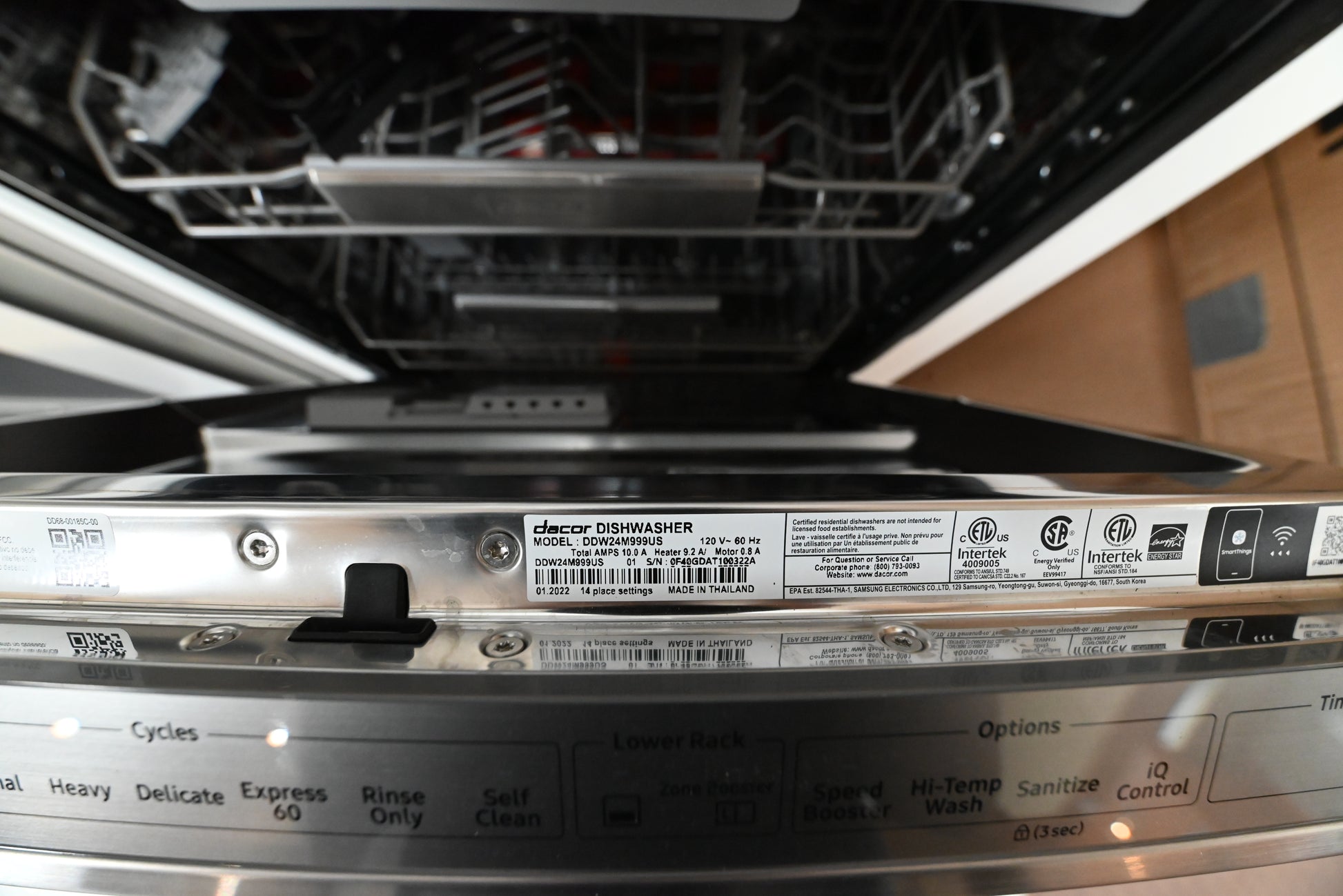 Dacor 24 inch dishwasher open showing stainless steel tub and 3rd rack cutlery tray