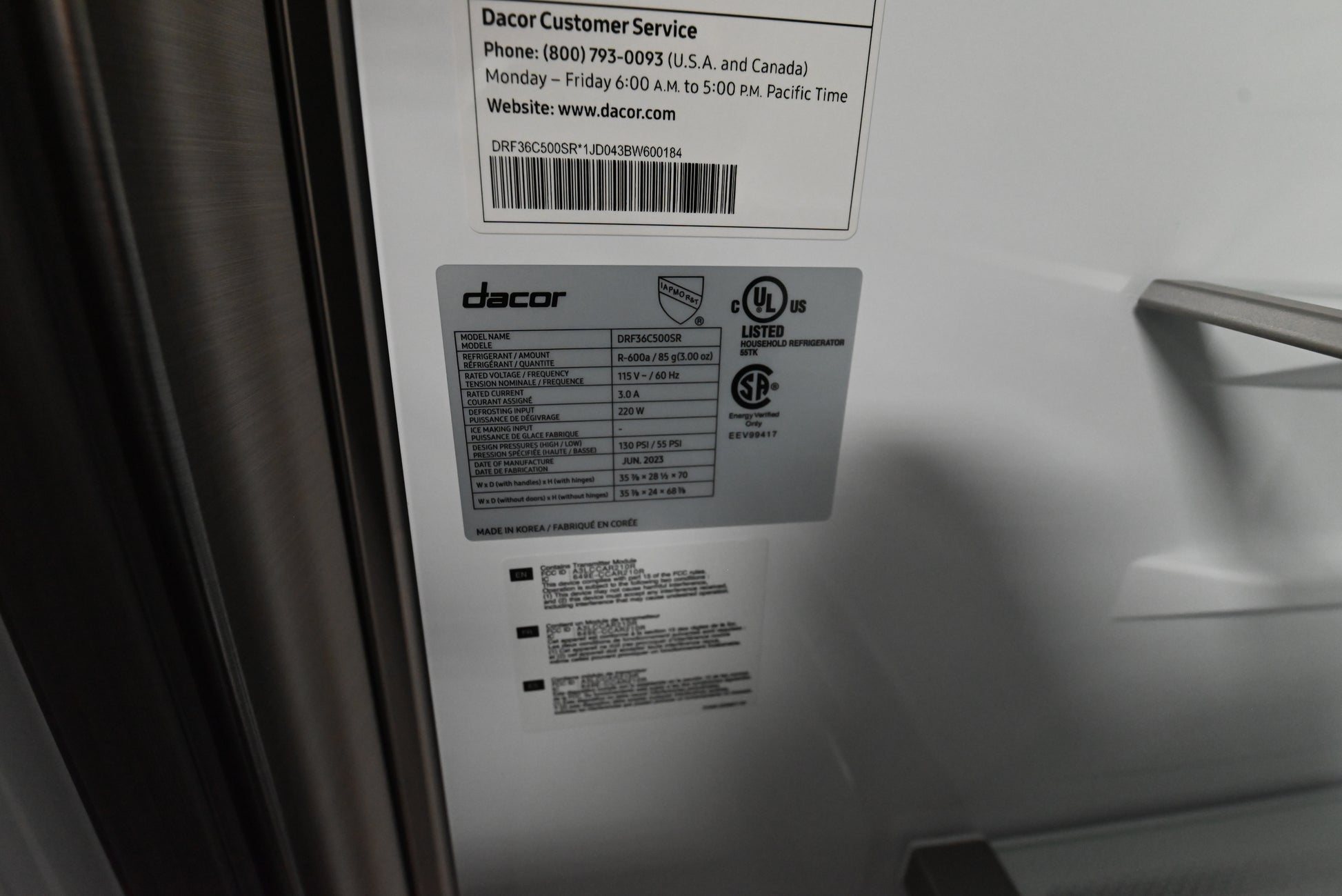 Dacor 4 door refrigerator open showing metal cooling stainless interior back wall