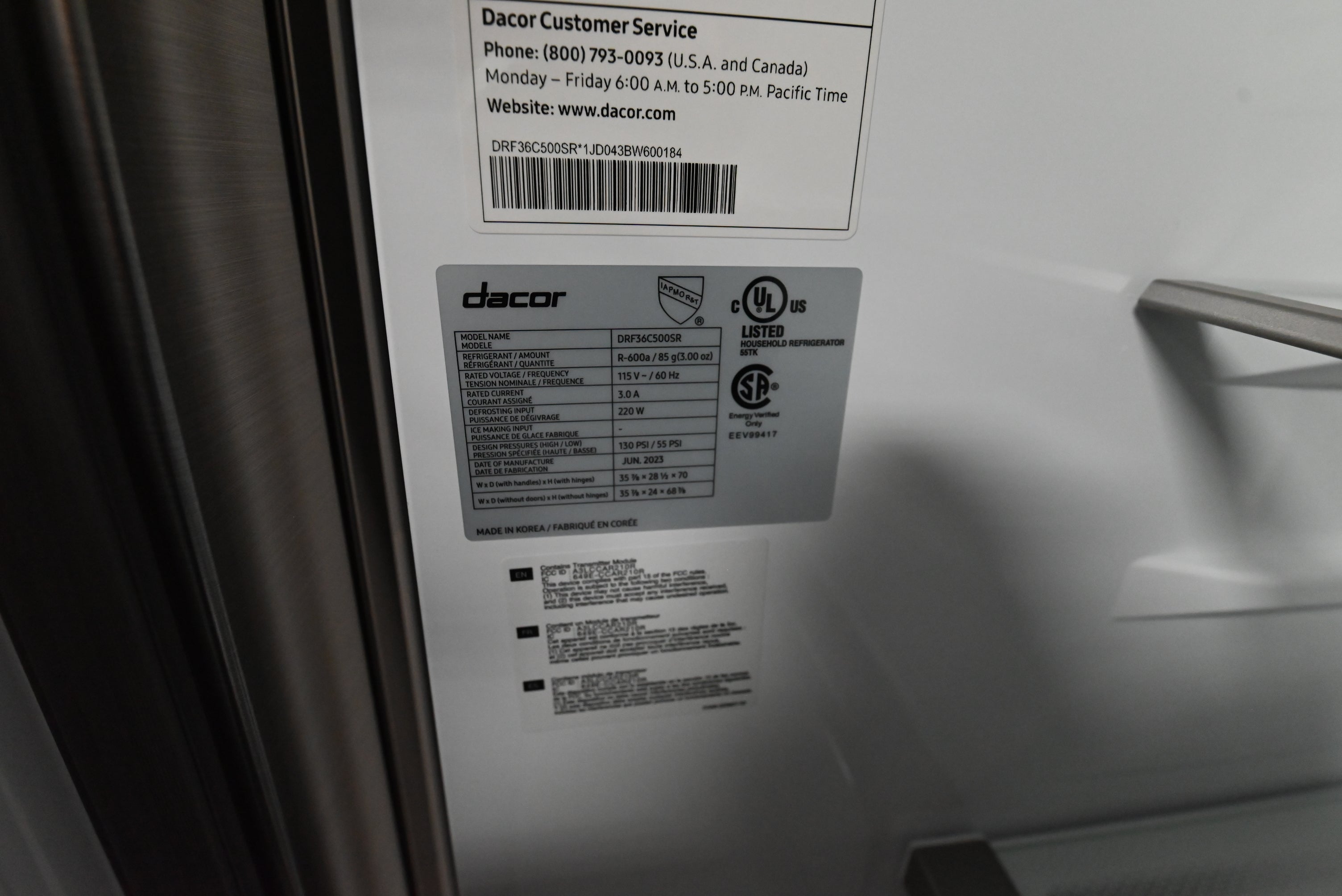 Dacor 4 door refrigerator open showing metal cooling stainless interior back wall