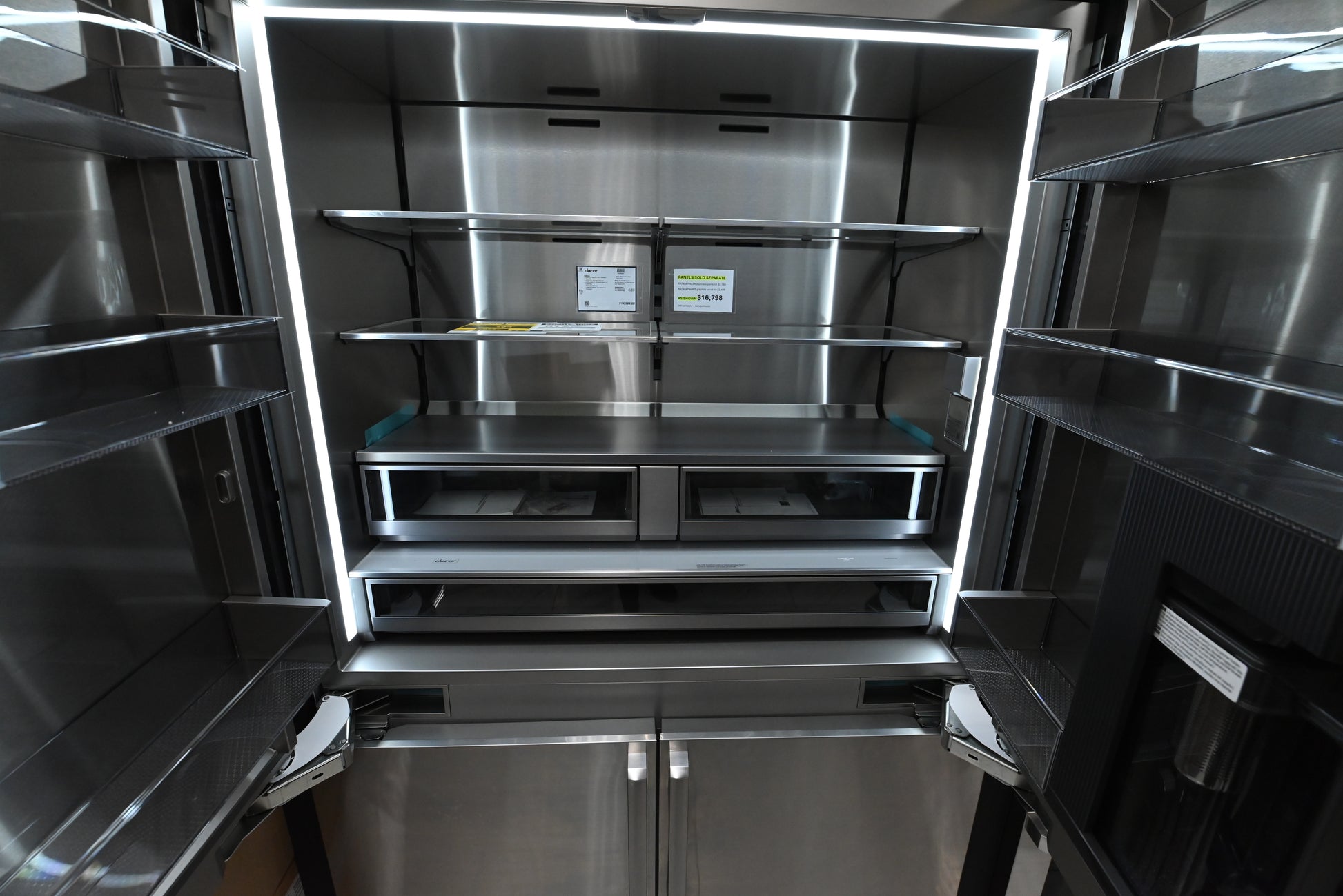Dacor 48 integrated refrigerator open showing multi zone triple cooling glass shelves