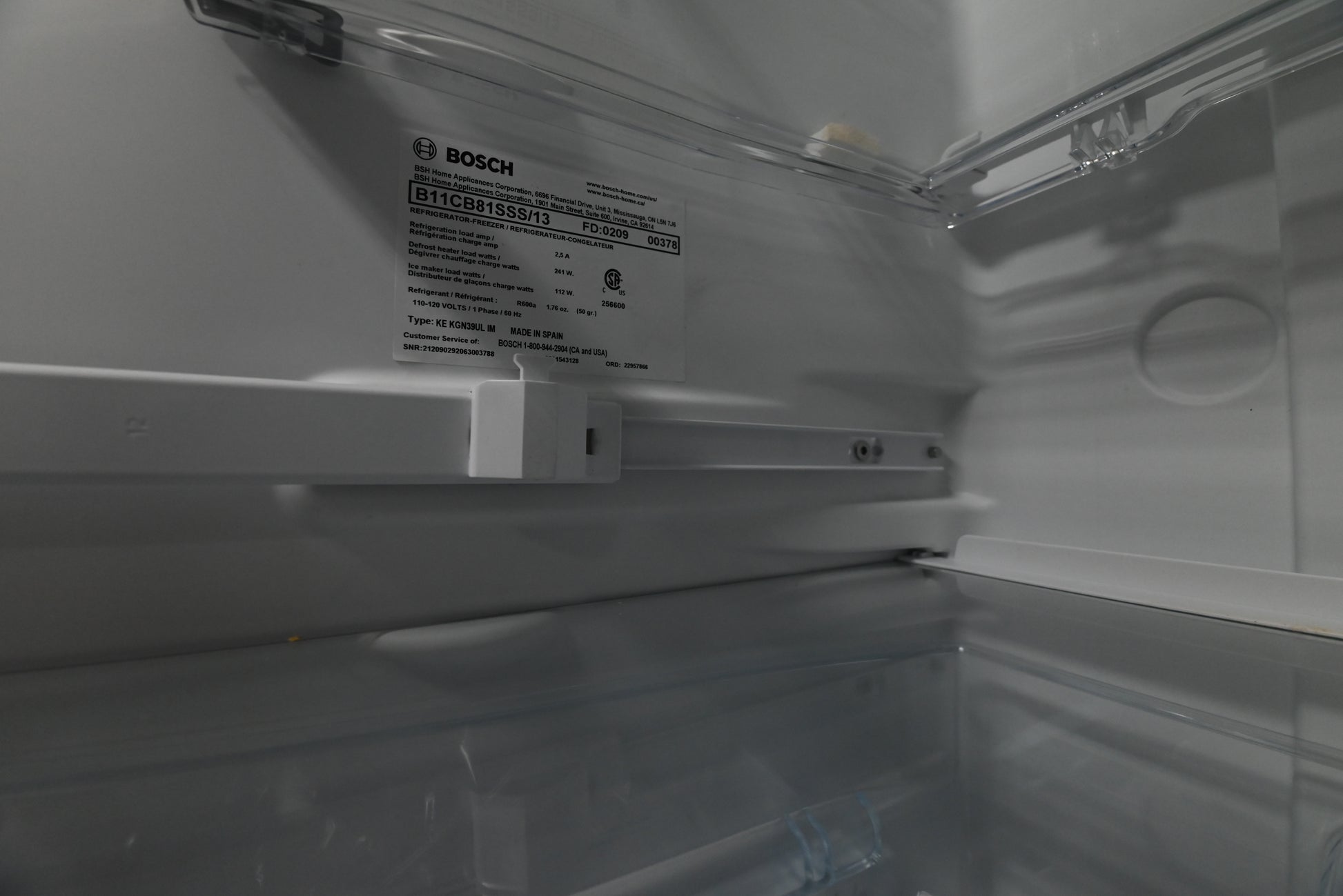 Bosch 24 refrigerator showing bottom freezer drawer opened with automatic ice maker