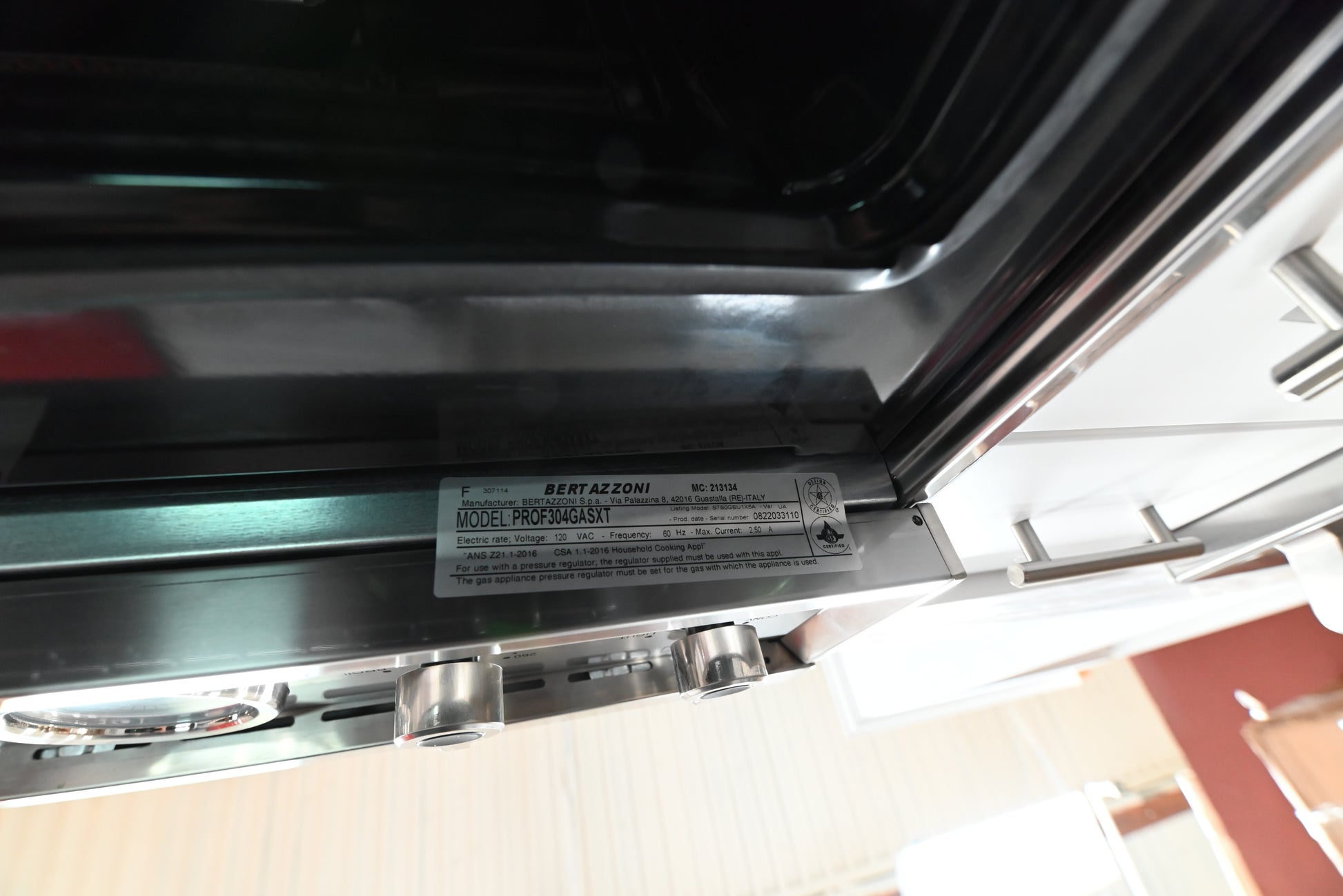 Bertazzoni gas range oven door open showing blue porcelain cavity and extension glide rack