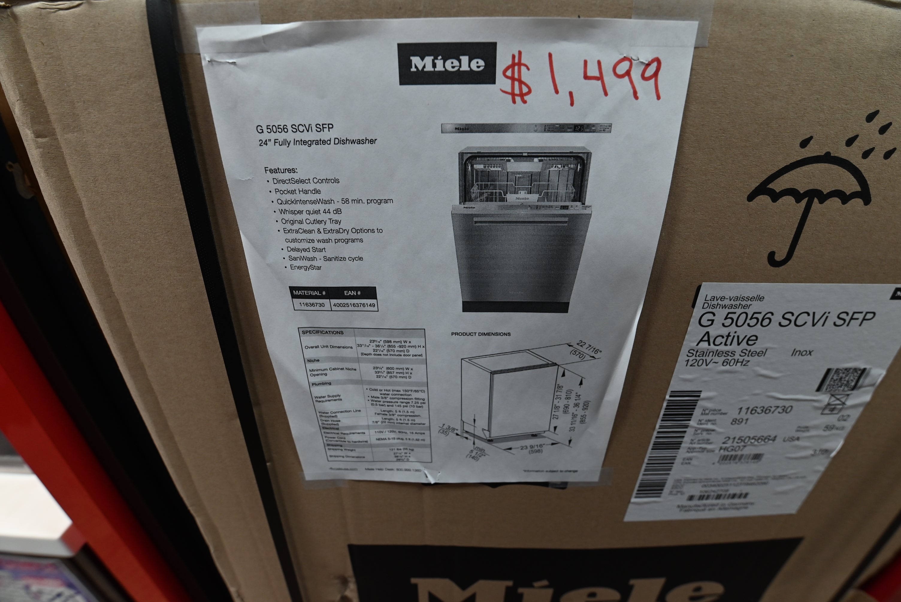 Luxury 24 inch Miele integrated dishwasher door open showing stainless steel tub three racks and original cutlery tray
