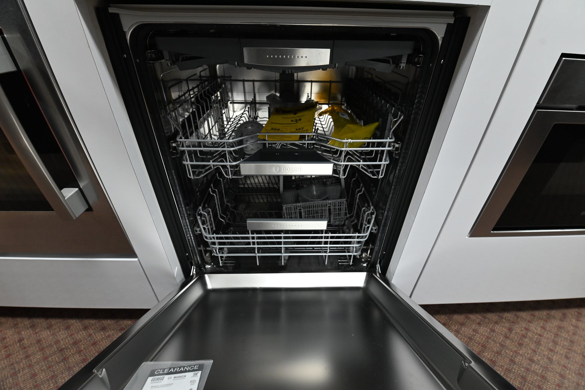 Luxury 24 inch custom panel dishwasher open showing full stainless steel tub and 3 telescopic racks