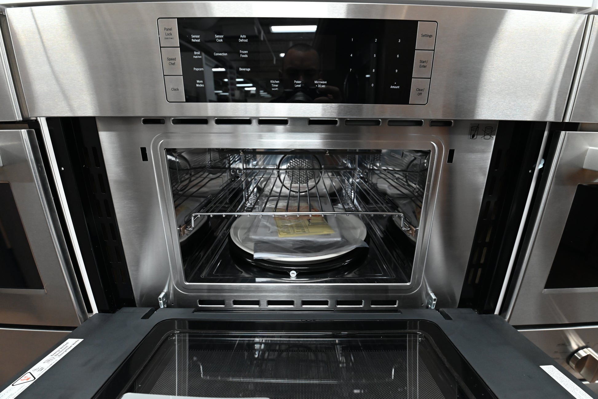 Luxury 30 inch integrated 2 in 1 speed oven open showing stainless steel interior and wire grids