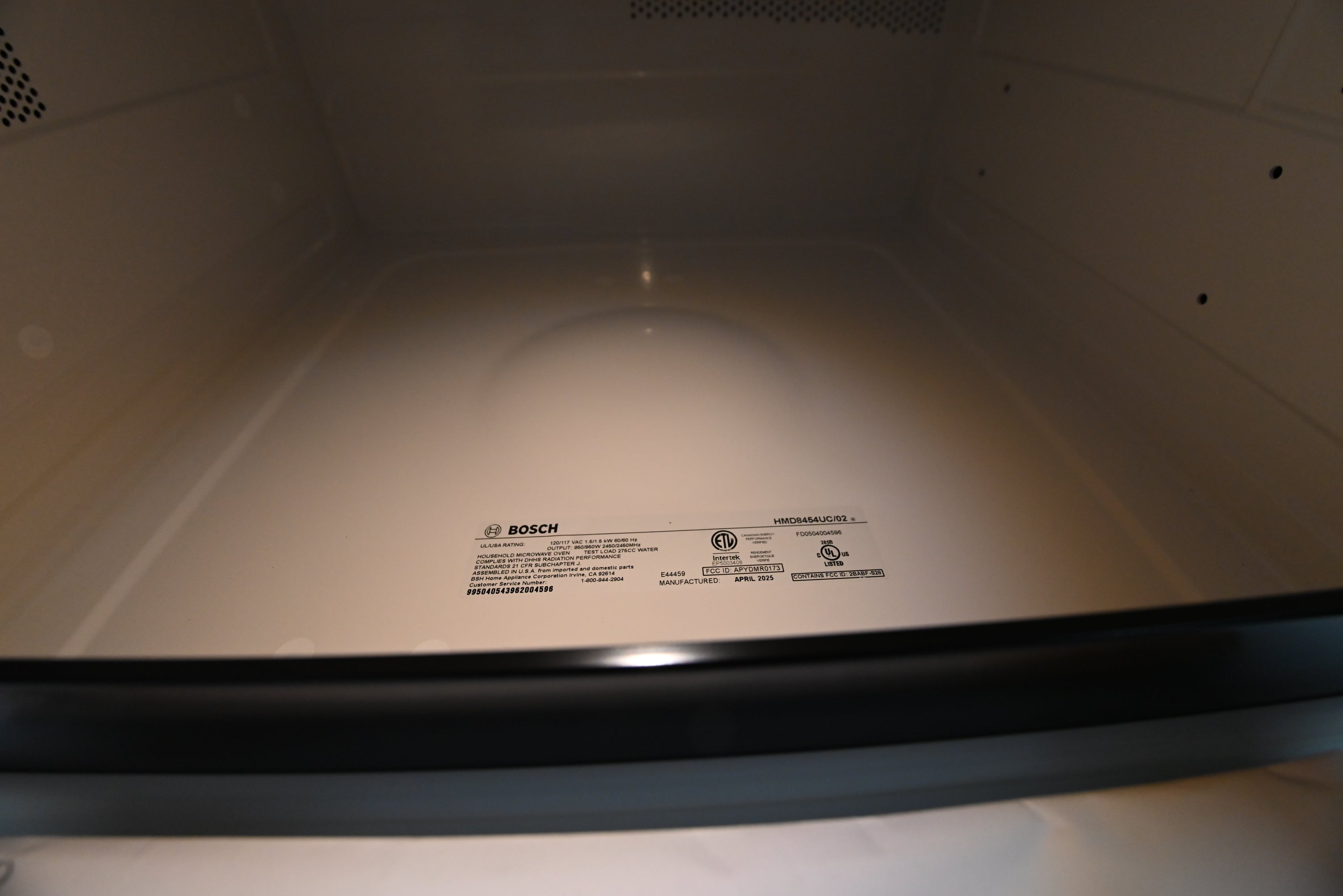 Bosch 24 microwave drawer showing hidden tilt out touch control display unfolded