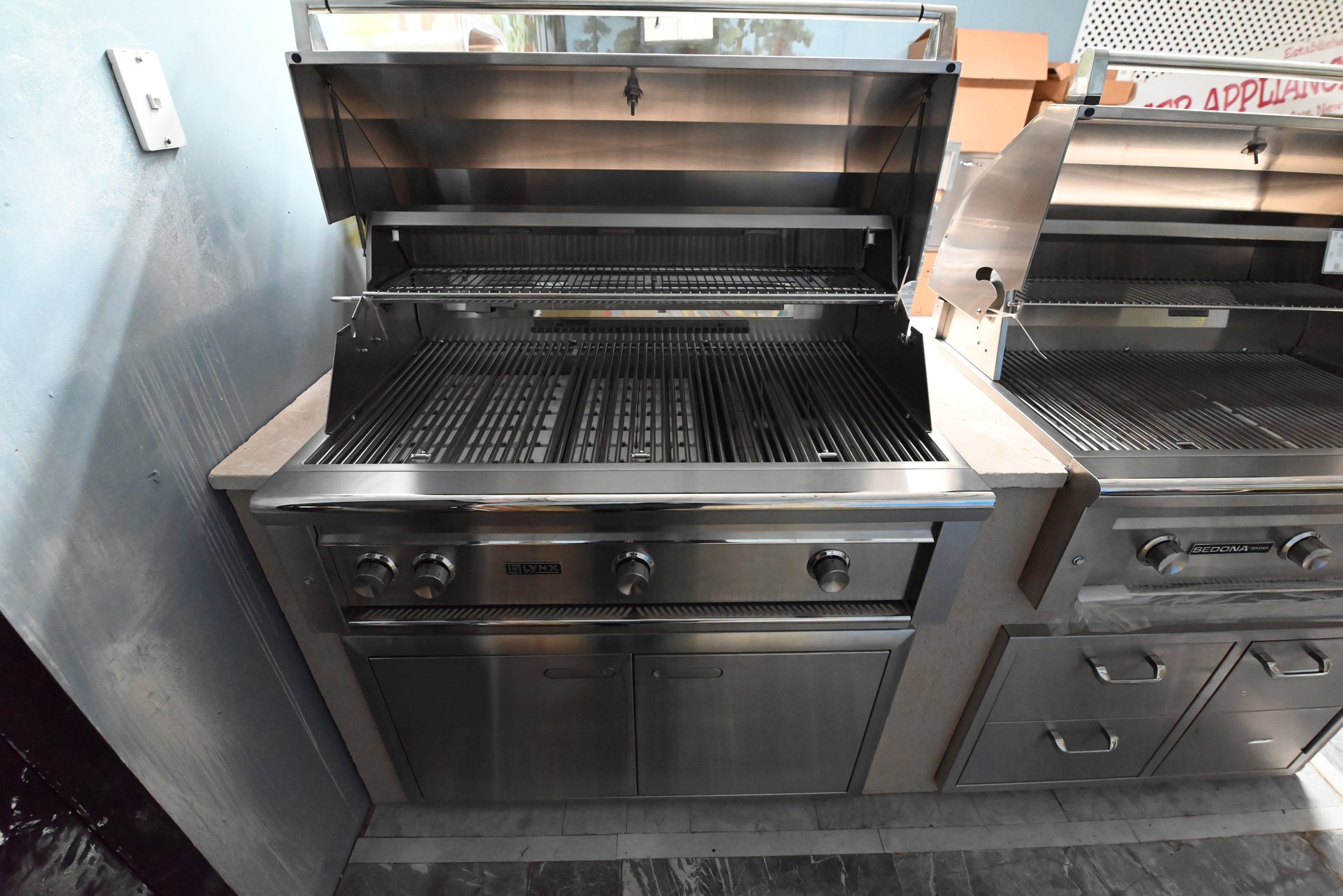 Luxury 42 inch outdoor built in grill island open showing ceramic briquette trays and trident infrared burner