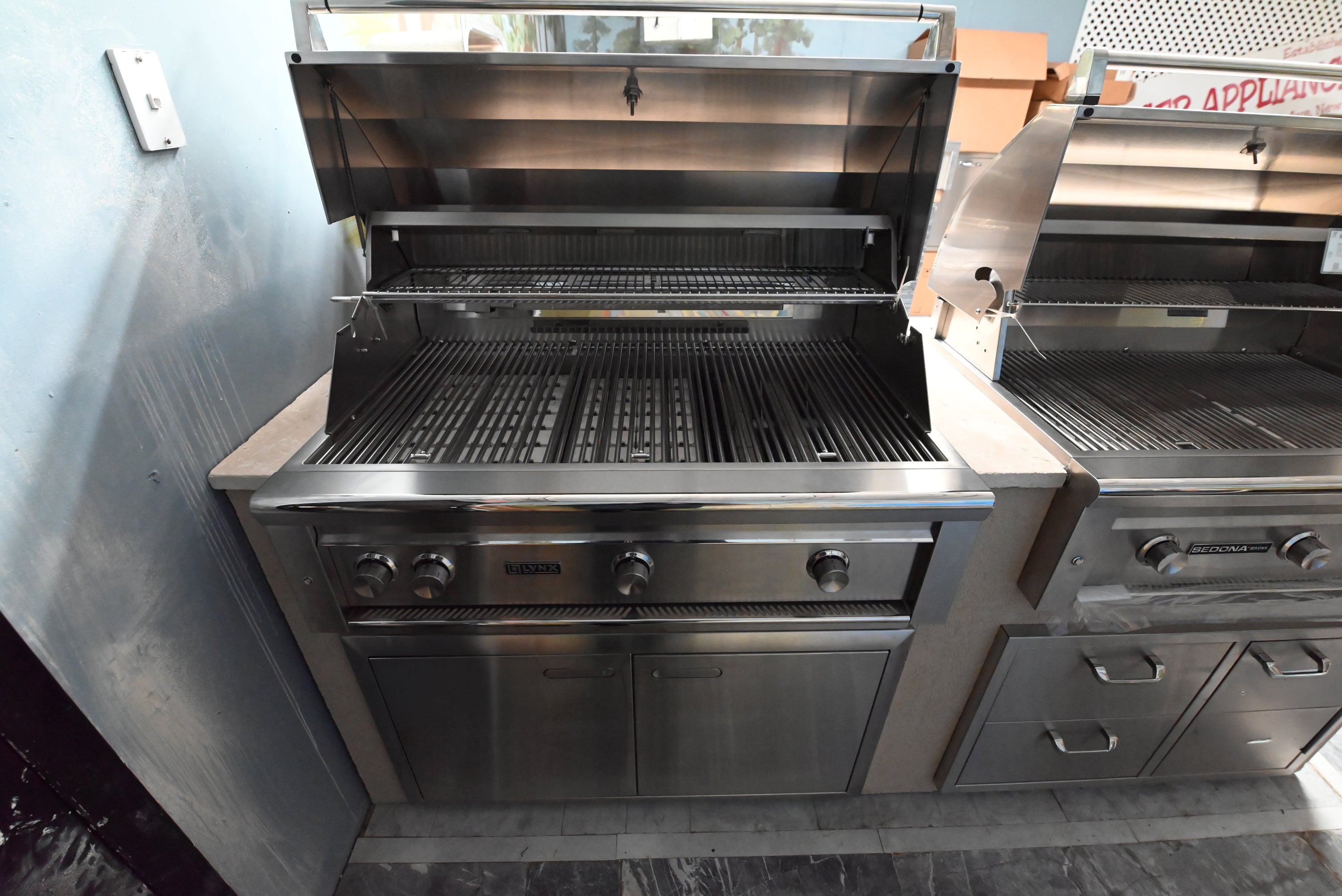 Luxury 42 inch outdoor built in grill island open showing ceramic briquette trays and trident infrared burner