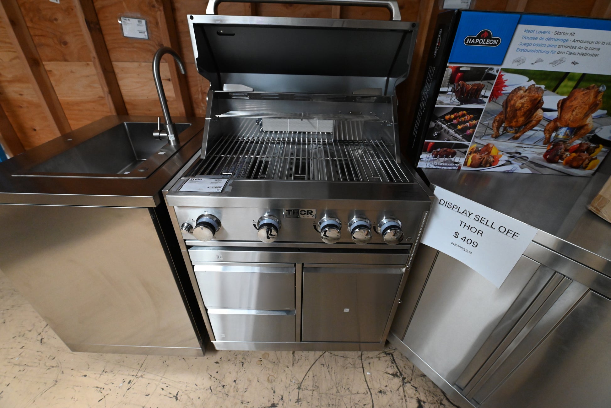 Luxury 32 inch freestanding outdoor gas grill cart open showing propane tank storage cavity by Thor Kitchen
