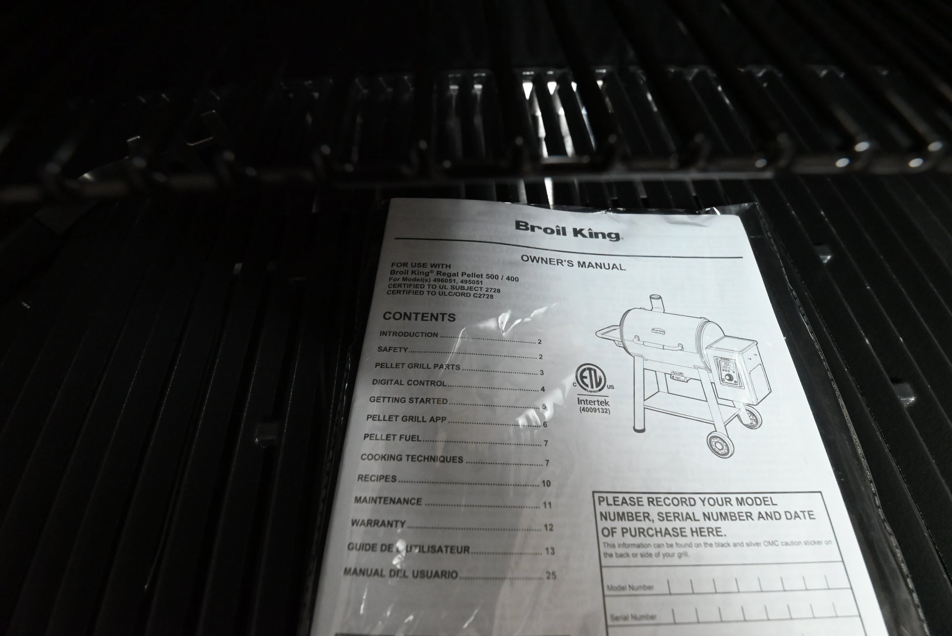 Broil King pellet 500 showing digital control board panel screen and 22 pound hopper
