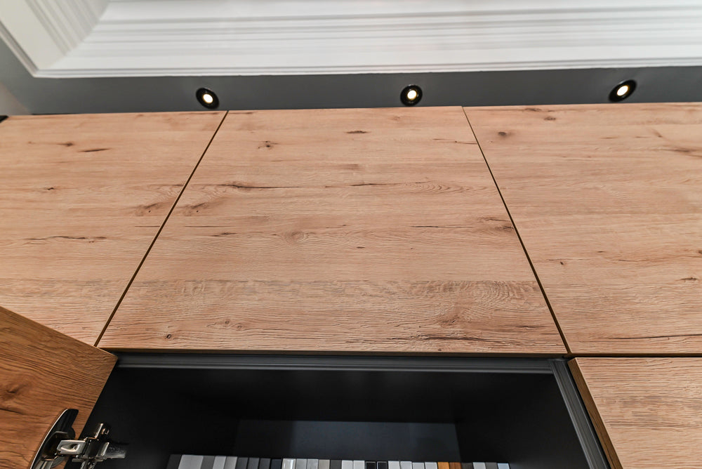 Nolte Küchen Modern Black Kitchen with Unique Accent Wall Cabinetry