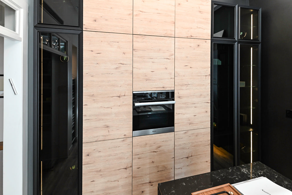 Nolte Küchen Modern Black Kitchen with Unique Accent Wall Cabinetry