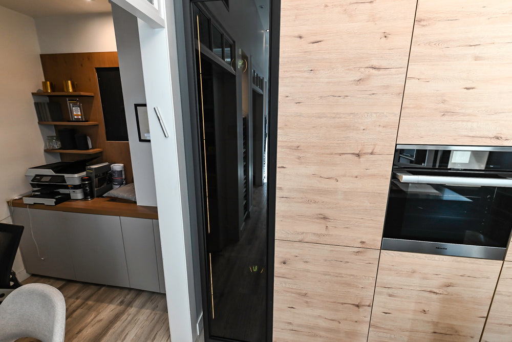 Nolte Küchen Modern Black Kitchen with Unique Accent Wall Cabinetry