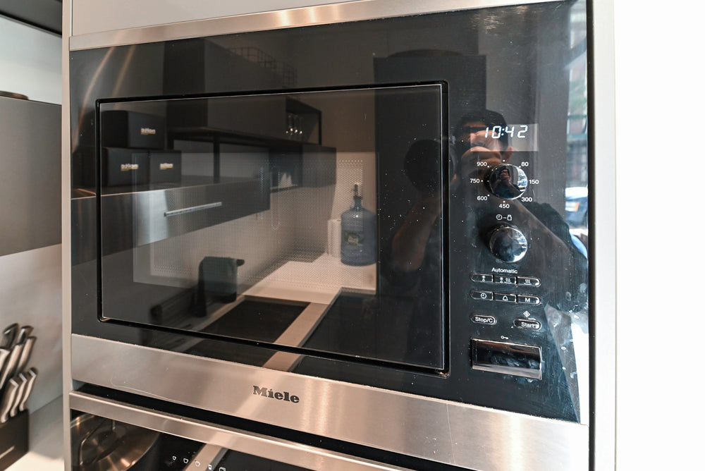 Modern Dark Grey Kitchenette with Quartz Countertops & Miele Appliances