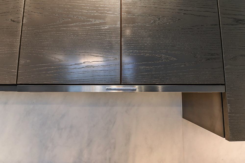 Modern White and Brown Wood Veneer Kitchen with Waterfall Island, Marble Countertops & Miele Appliances
