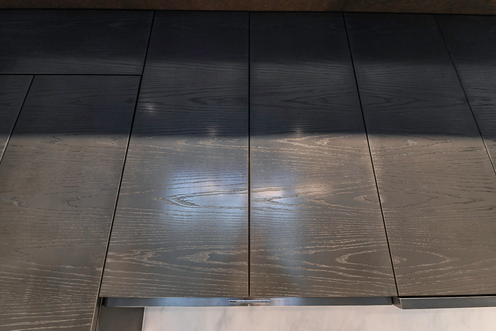 Modern White and Brown Wood Veneer Kitchen with Waterfall Island, Marble Countertops & Miele Appliances