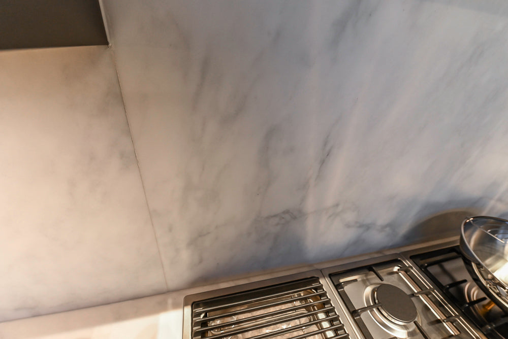 Modern White and Brown Wood Veneer Kitchen with Waterfall Island, Marble Countertops & Miele Appliances