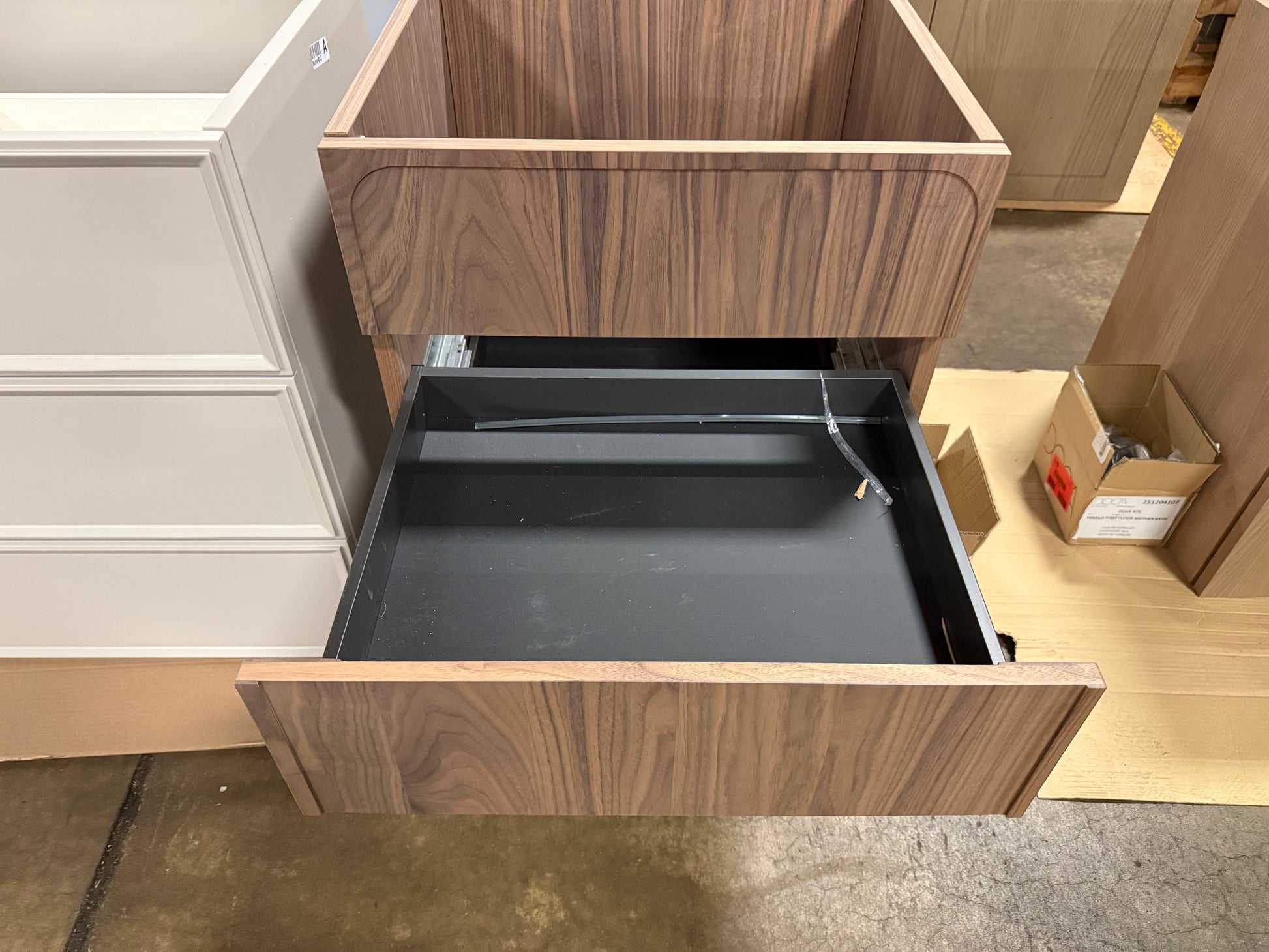 Close up view of the rich walnut linear wood grain on the doors of a DOCA 24 inch vanity base