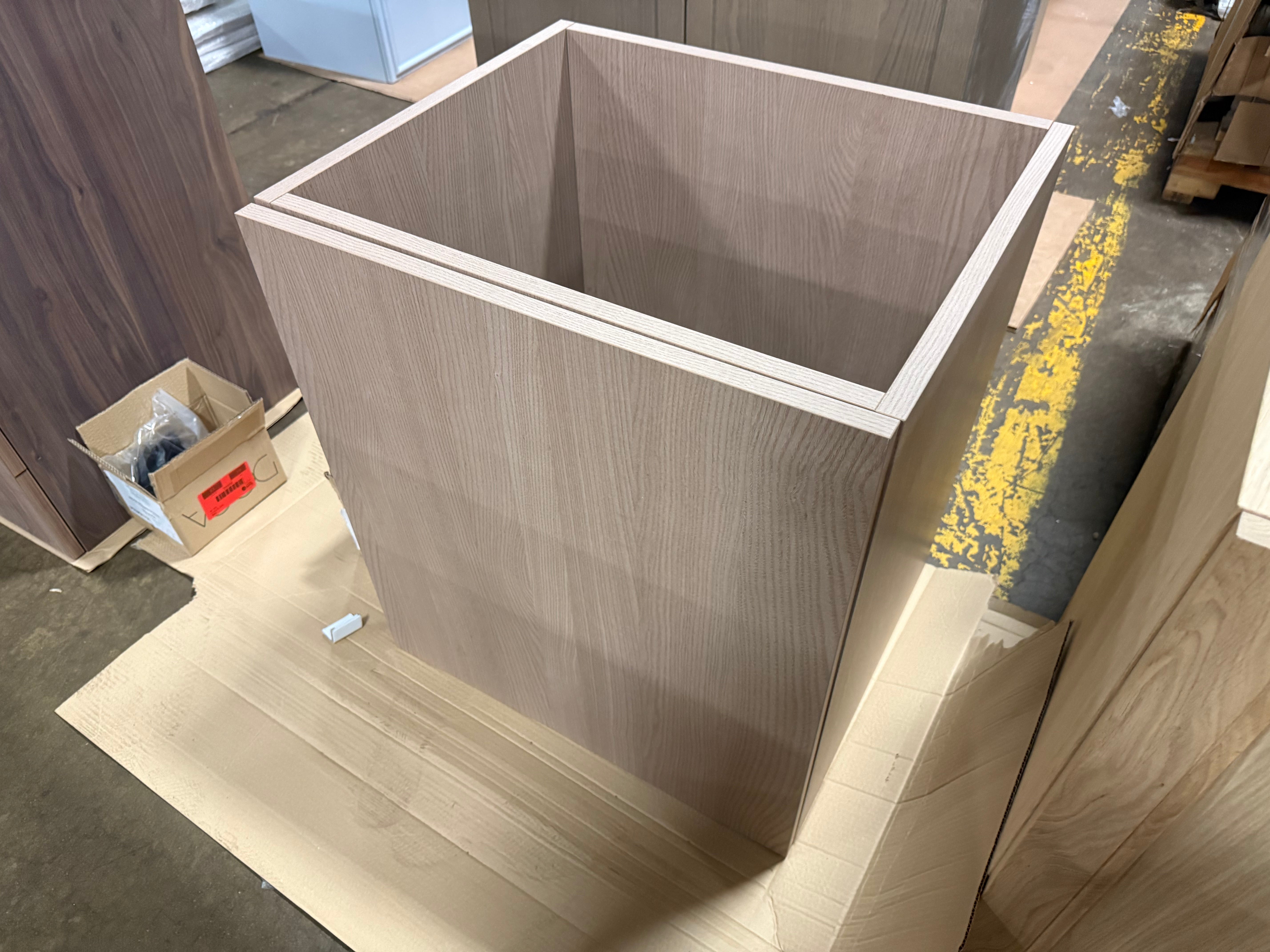 Contemporary bathroom interior featuring an uninstalled 26 inch freestanding DOCA vanity base awaiting a quartz top