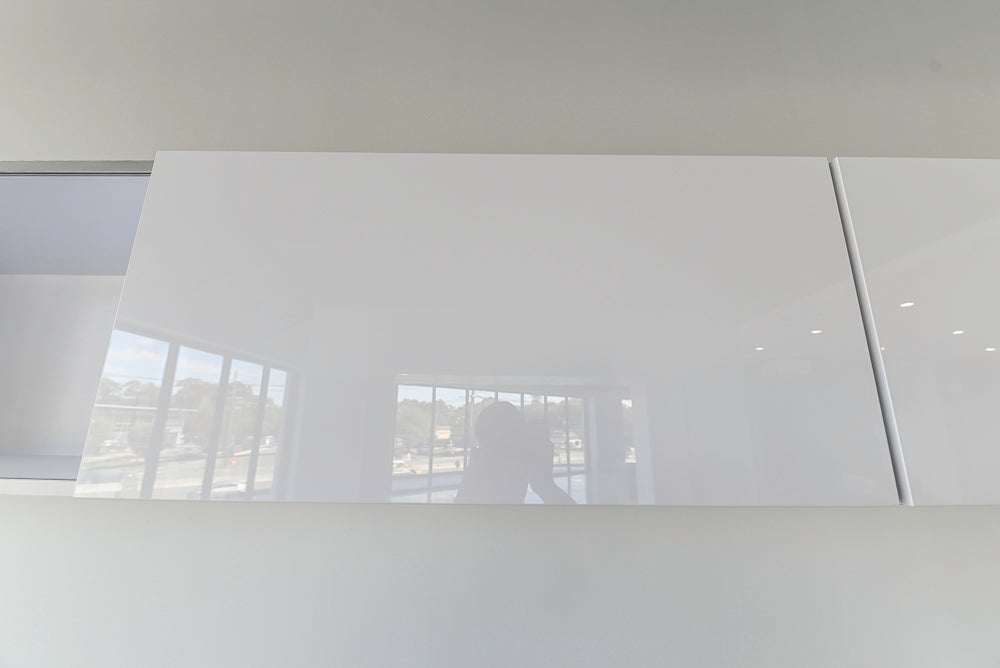 Häcker Modern Glossy White Kitchen with Island and Black Quartz Countertop