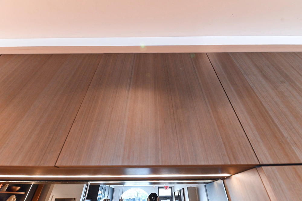 Composit Modern White & Brown Wood Veneer Kitchen with Enigma Countertops and Wolf Cooktop