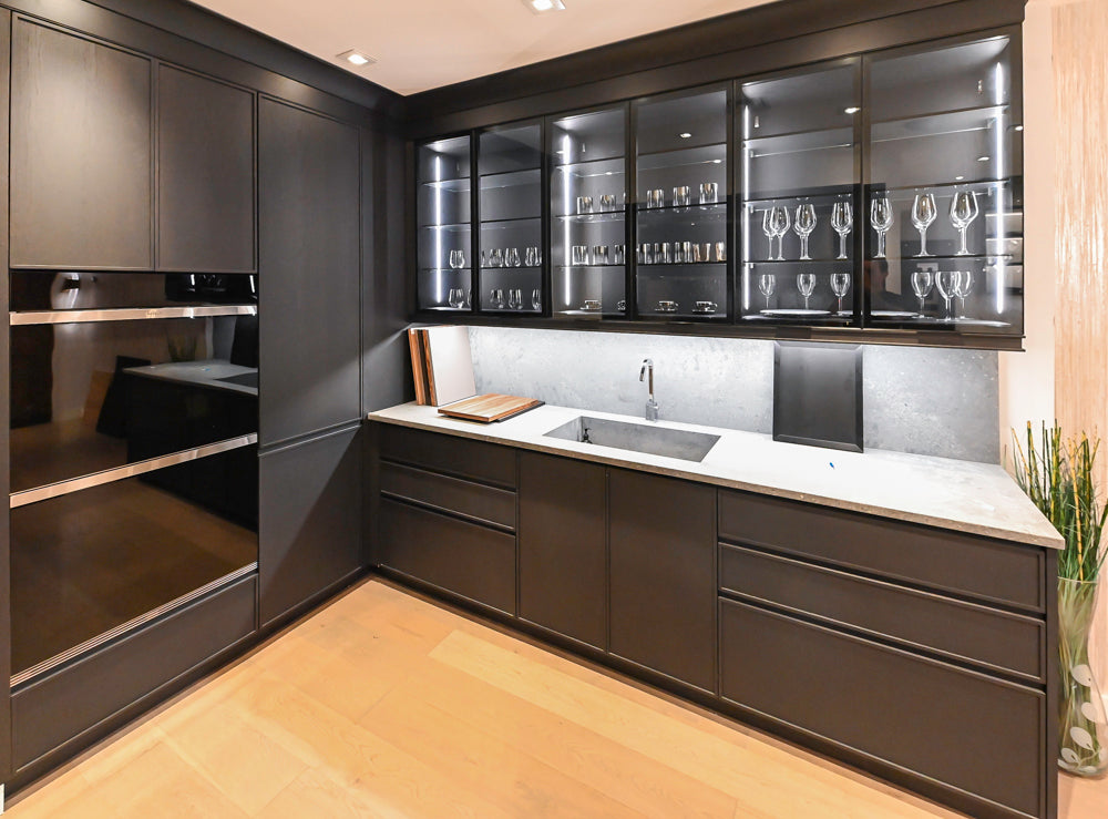 DOCA Modern Dark Brown Wood Veneer Kitchen Corner with White Ceasarstone Countertop & Integrated Sink