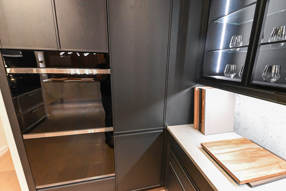 DOCA Modern Dark Brown Wood Veneer Kitchen Corner with White Ceasarstone Countertop & Integrated Sink