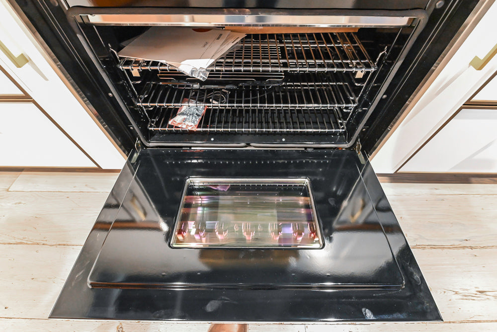Wolf 36 professional range oven interior showing blue porcelain liner and three adjustable racks