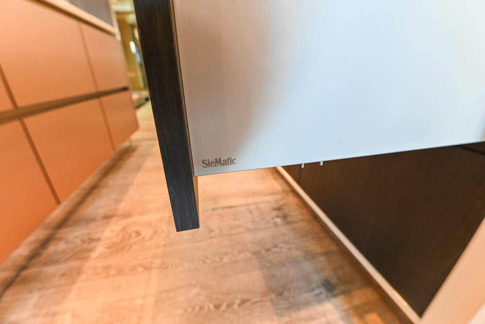 SieMatic S2 Modern Rose Gold Handleless Island with Lotus White Hideaway Pantry
