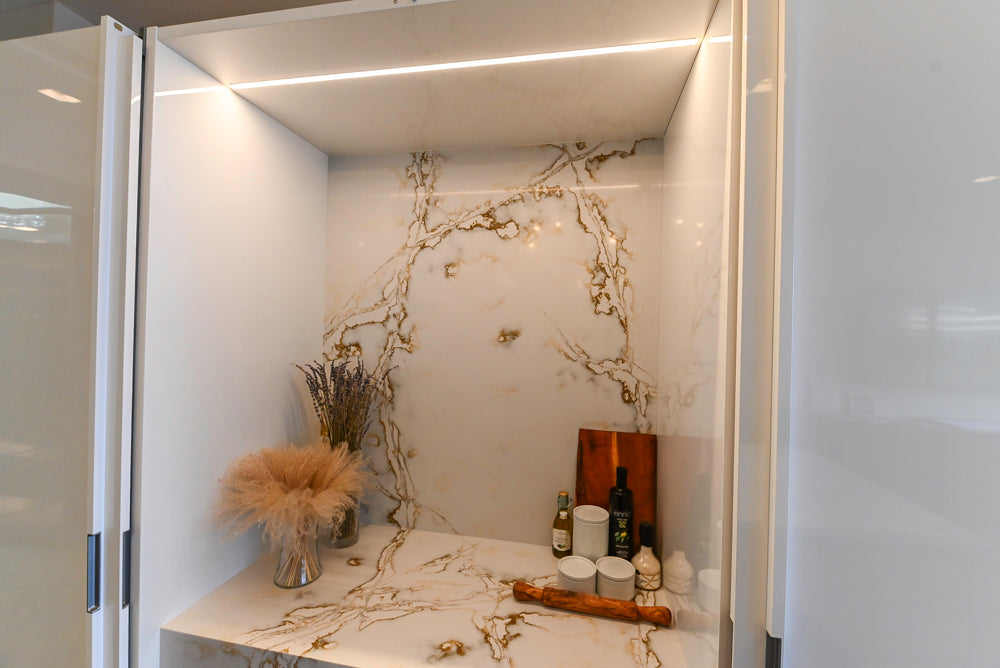 SieMatic S2 Modern Rose Gold Handleless Island with Lotus White Hideaway Pantry