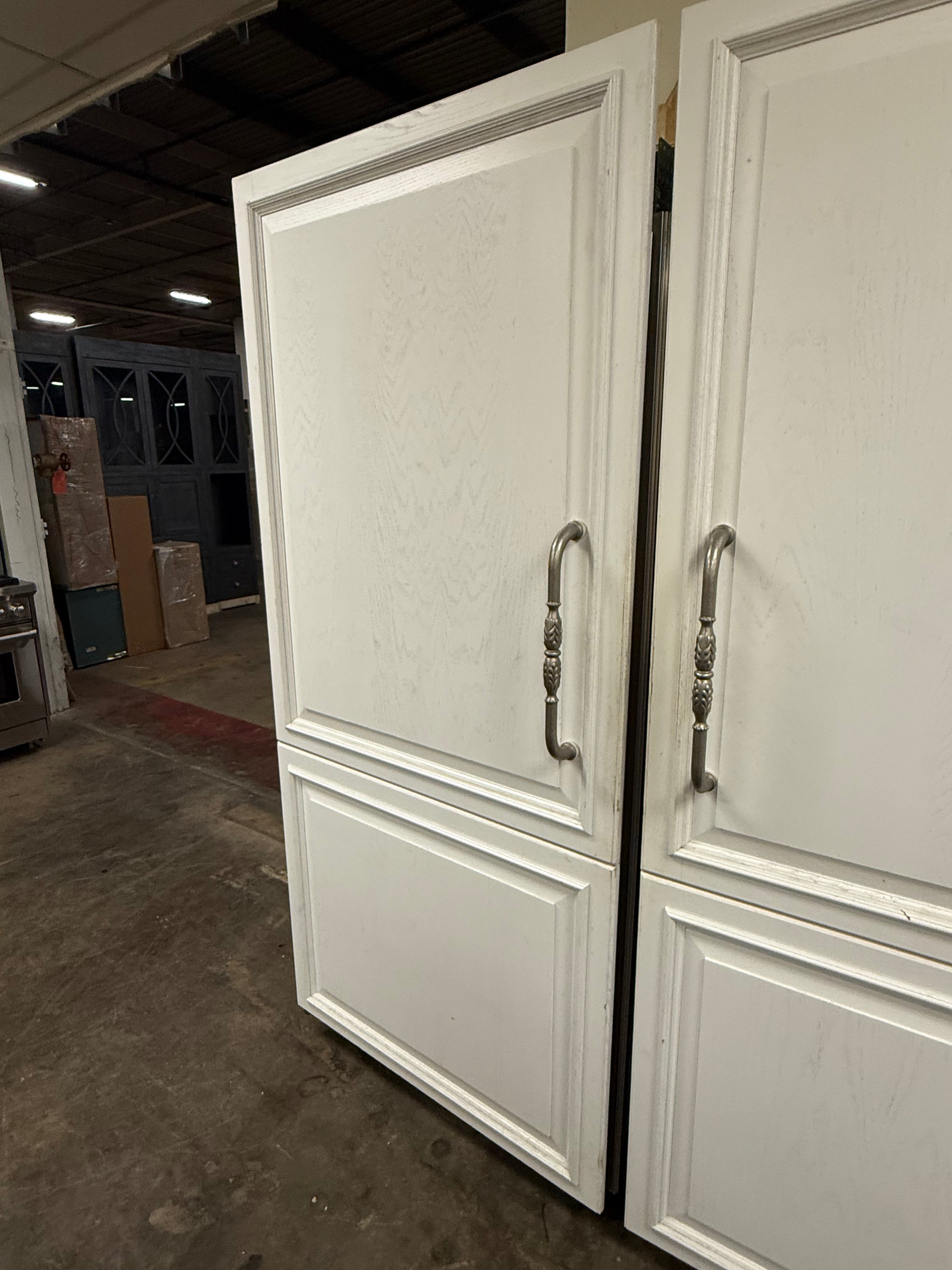 Luxury full height built in freezer column open showing high capacity wire baskets and automatic ice bin