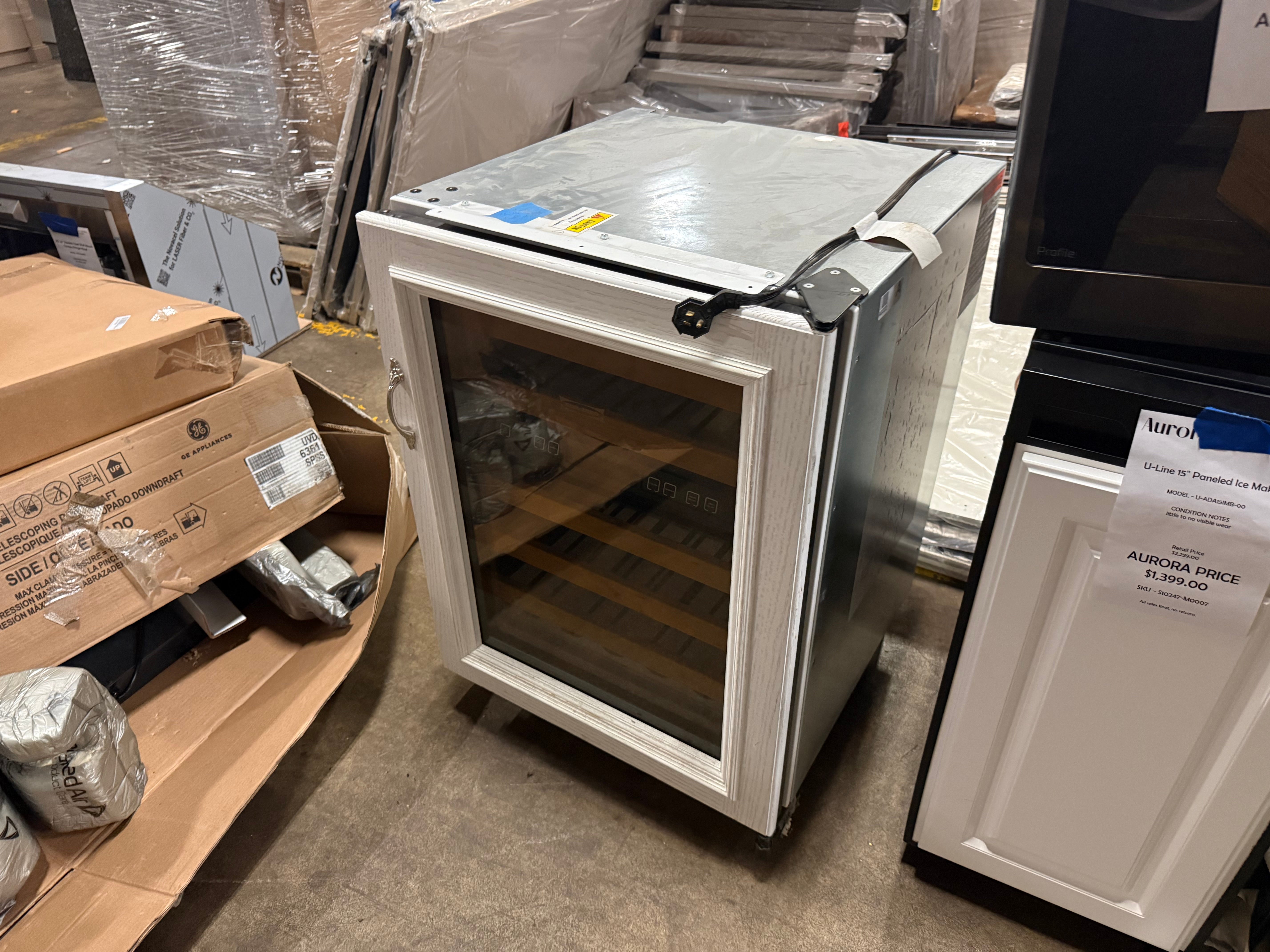 Luxury built in undercounter wine cooler open showing cherry wood faced roller glide shelves