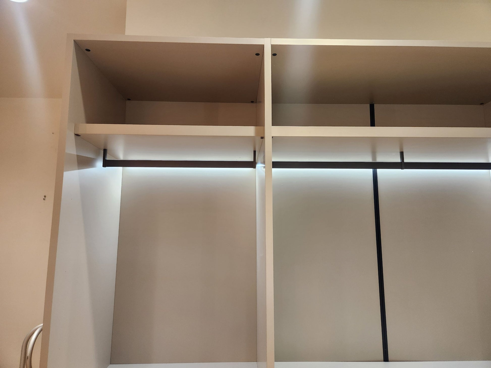 European minimalist wardrobe dressing room with custom shelving and accessory drawers