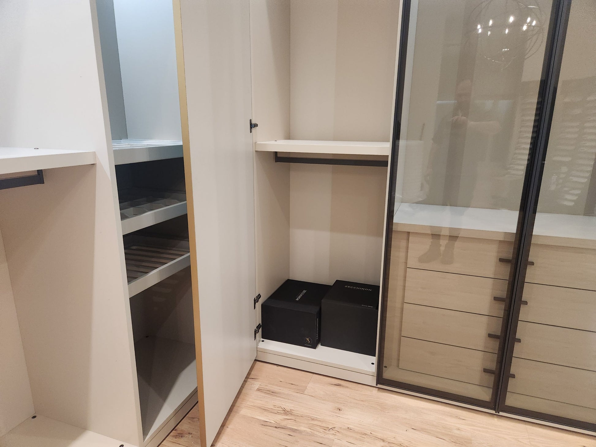European minimalist wardrobe dressing room with custom shelving and accessory drawers