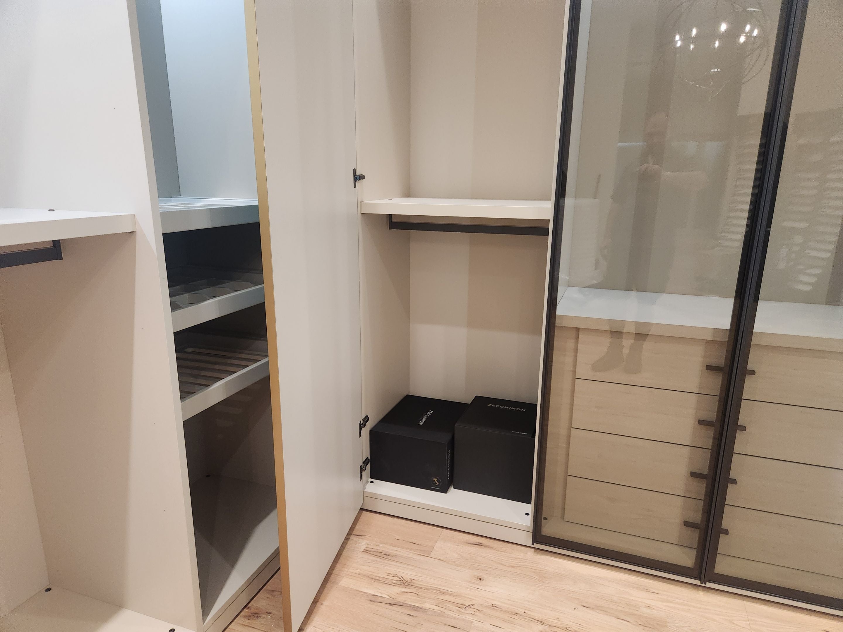European minimalist wardrobe dressing room with custom shelving and accessory drawers