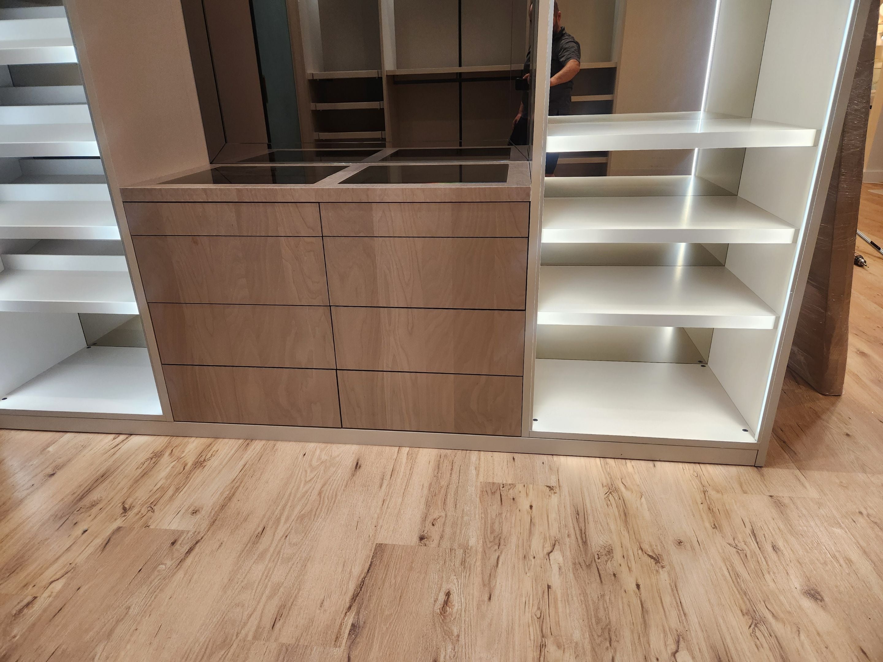 European minimalist wardrobe dressing room with custom shelving and accessory drawers