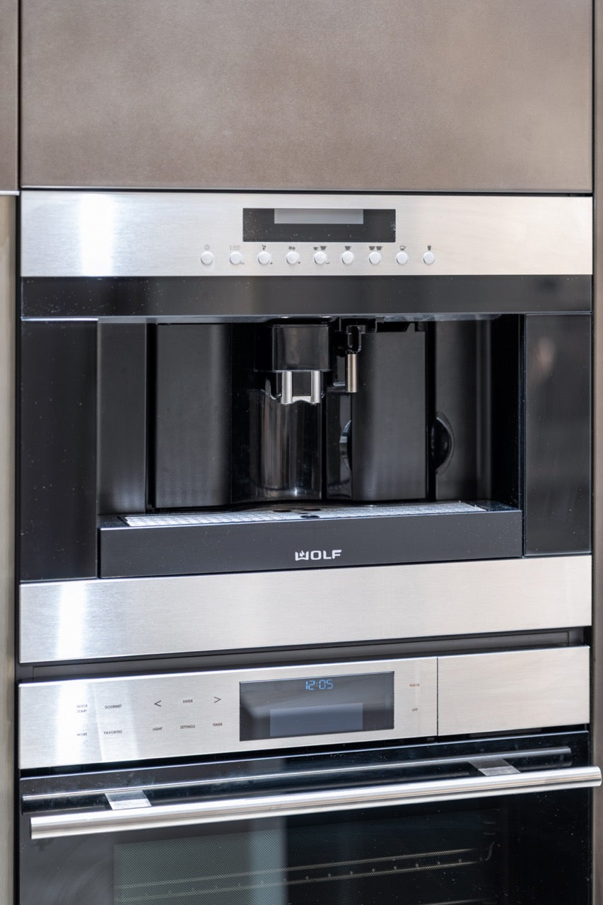 Composit Modern Brown Kitchen with Waterfall Island, Stone Countertops and Wolf & Sub-Zero Appliances