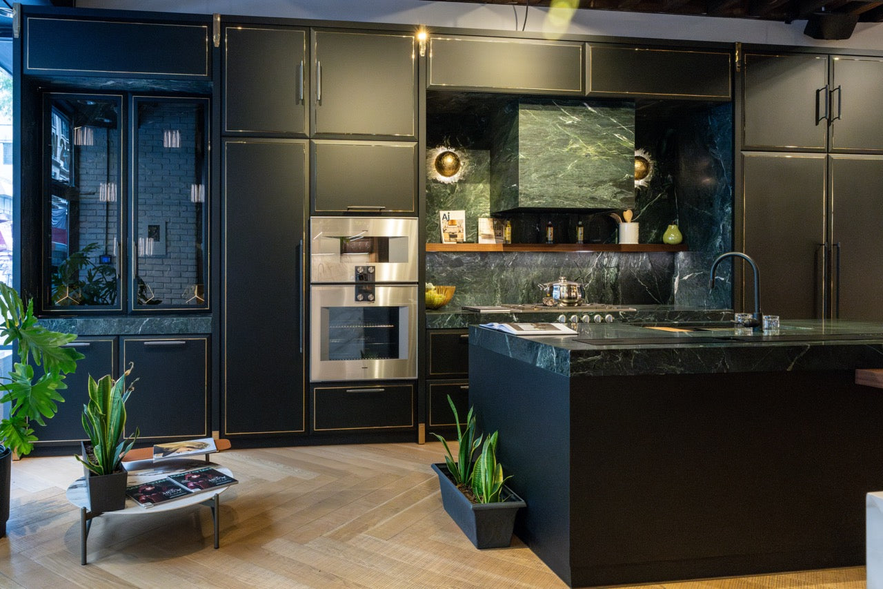 Martini Interiors modern matte black Nero Assoluto kitchen featuring a large central island and premium built in Gaggenau wall ovens
