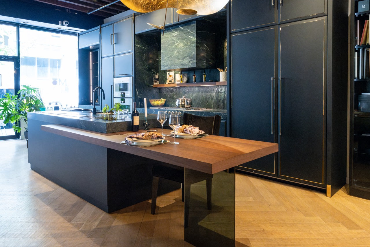 Luxury home interior showing a premium open concept Martini Italian kitchen package with a large minimalist island facing a dining space