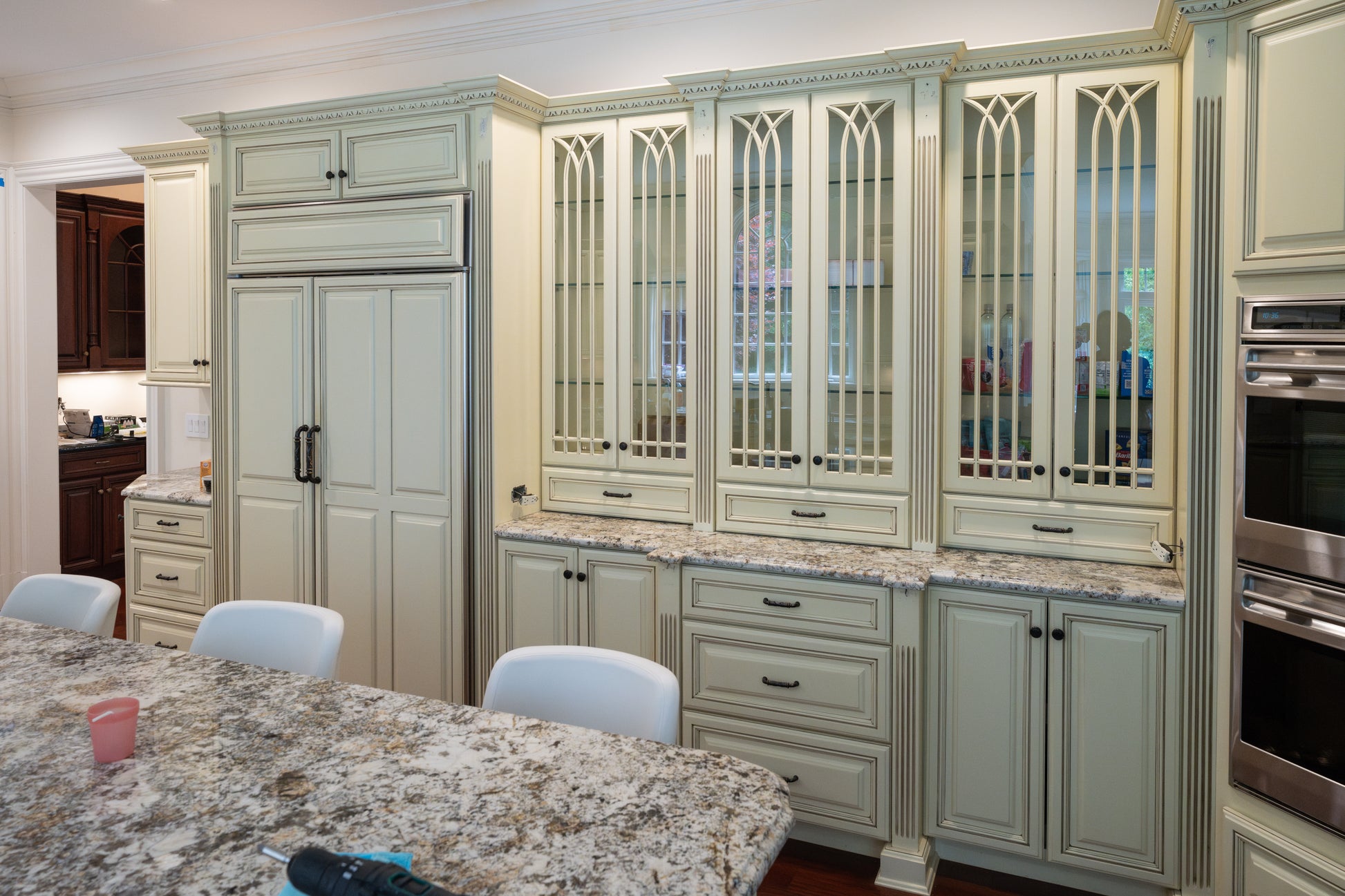 Pre owned estate kitchen package featuring raised panel cream cabinets and large central island