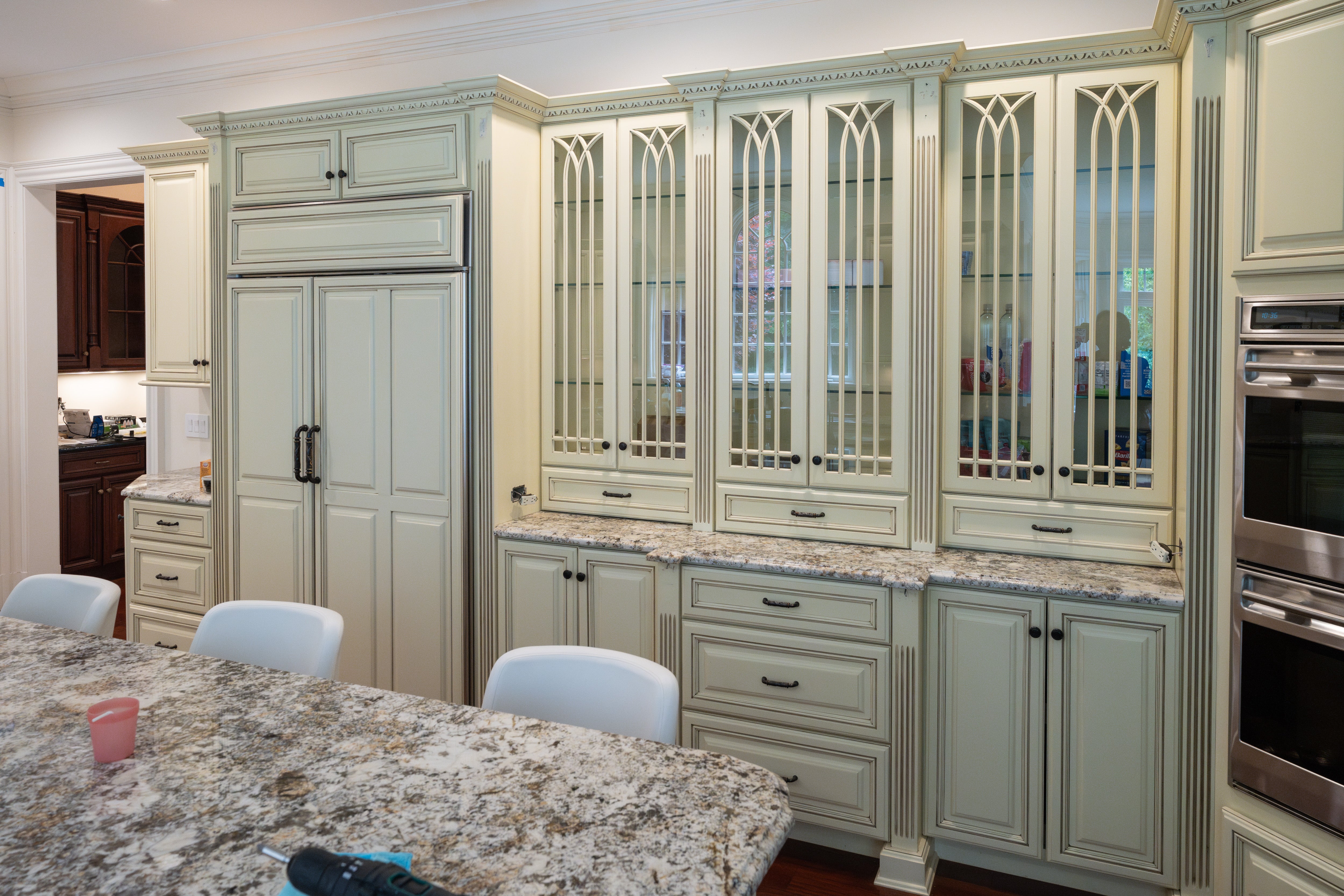 Pre owned estate kitchen package featuring raised panel cream cabinets and large central island