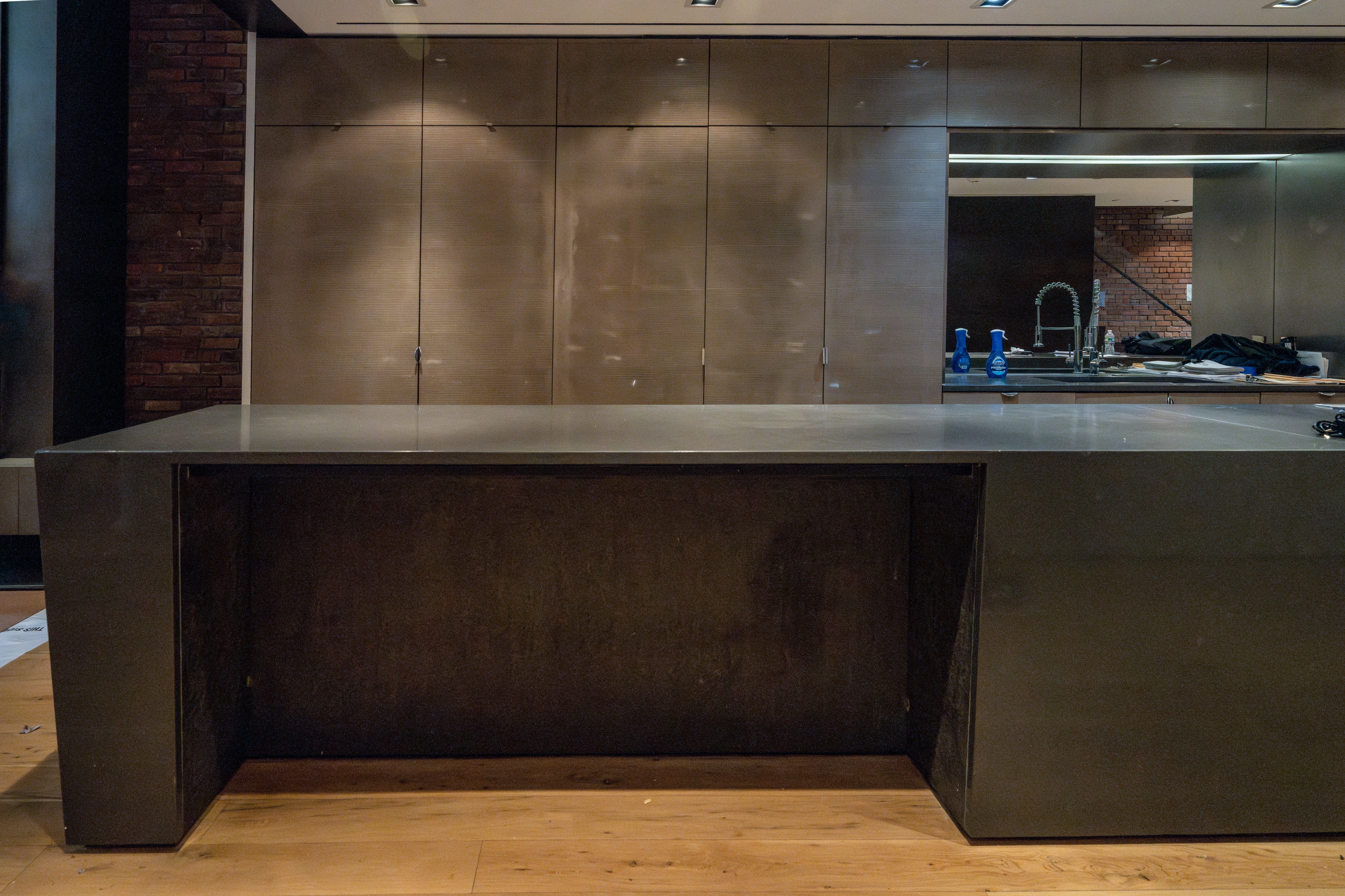 The Stryker industrial modern kitchen cabinetry with center island and integrated Gaggenau appliances