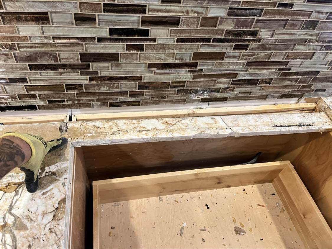 Kraftmaid Transitional Dark Wooden Kitchen with Marble Countertops and GE Monogram Appliances