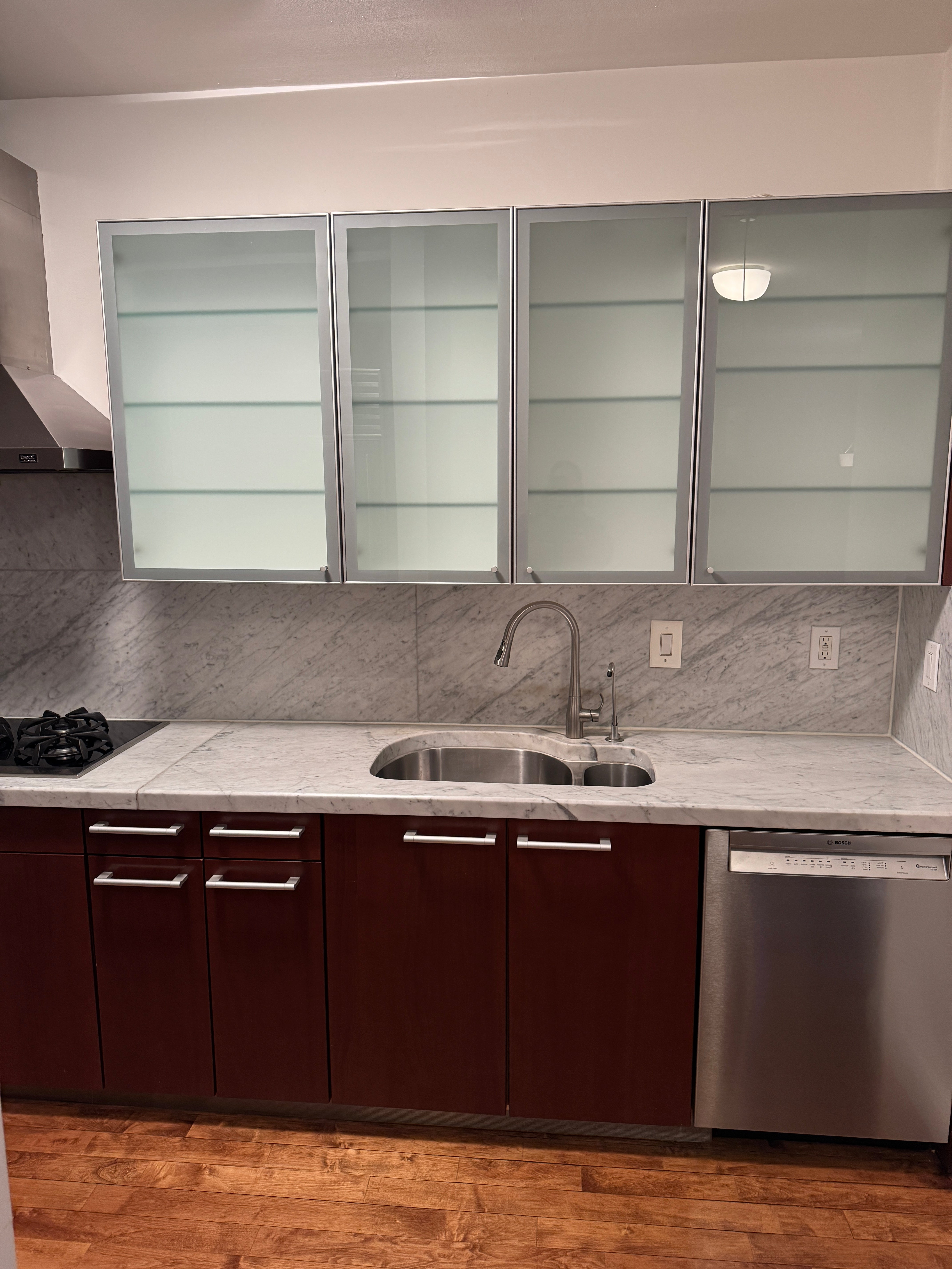 Poggenpohl Brown Toned Transitional Kitchen with Marble Countertops and Appliances