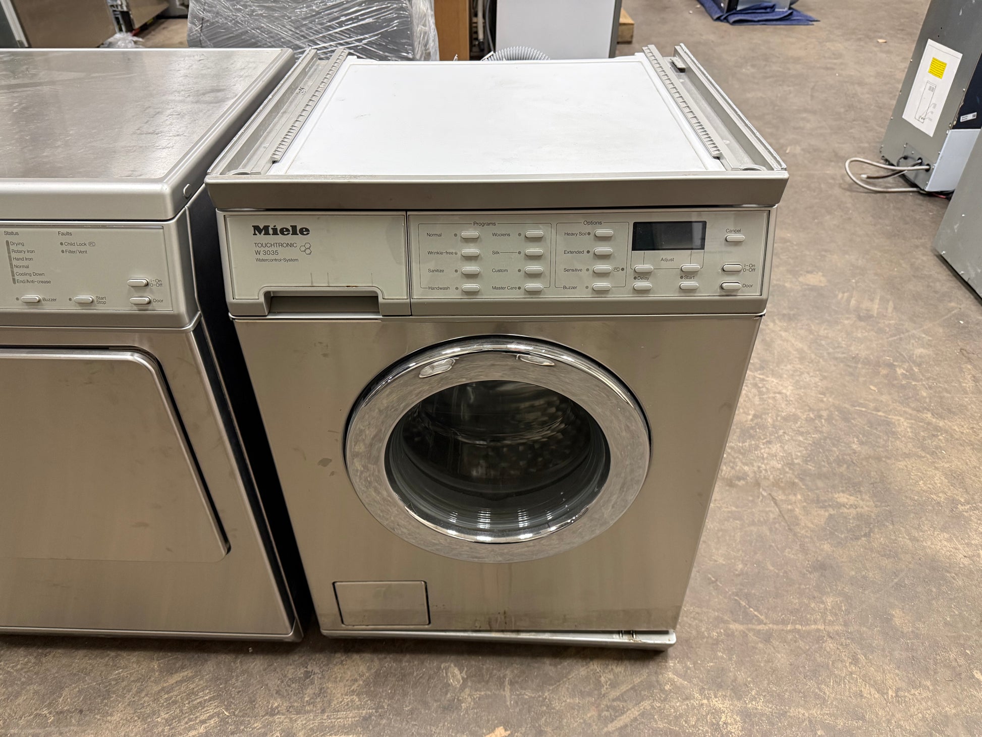 Compact Miele professional laundry suite in a stainless steel finish