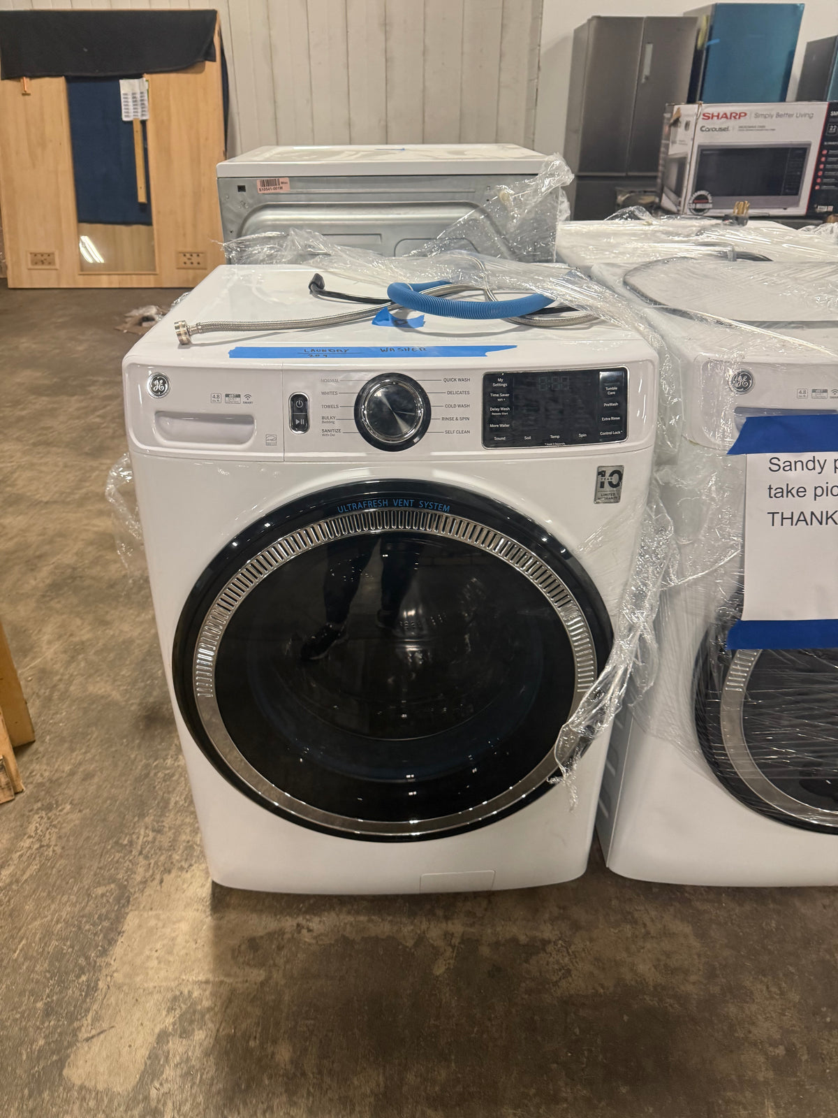 Luxury white front load washing machine with odorblock and microban protection