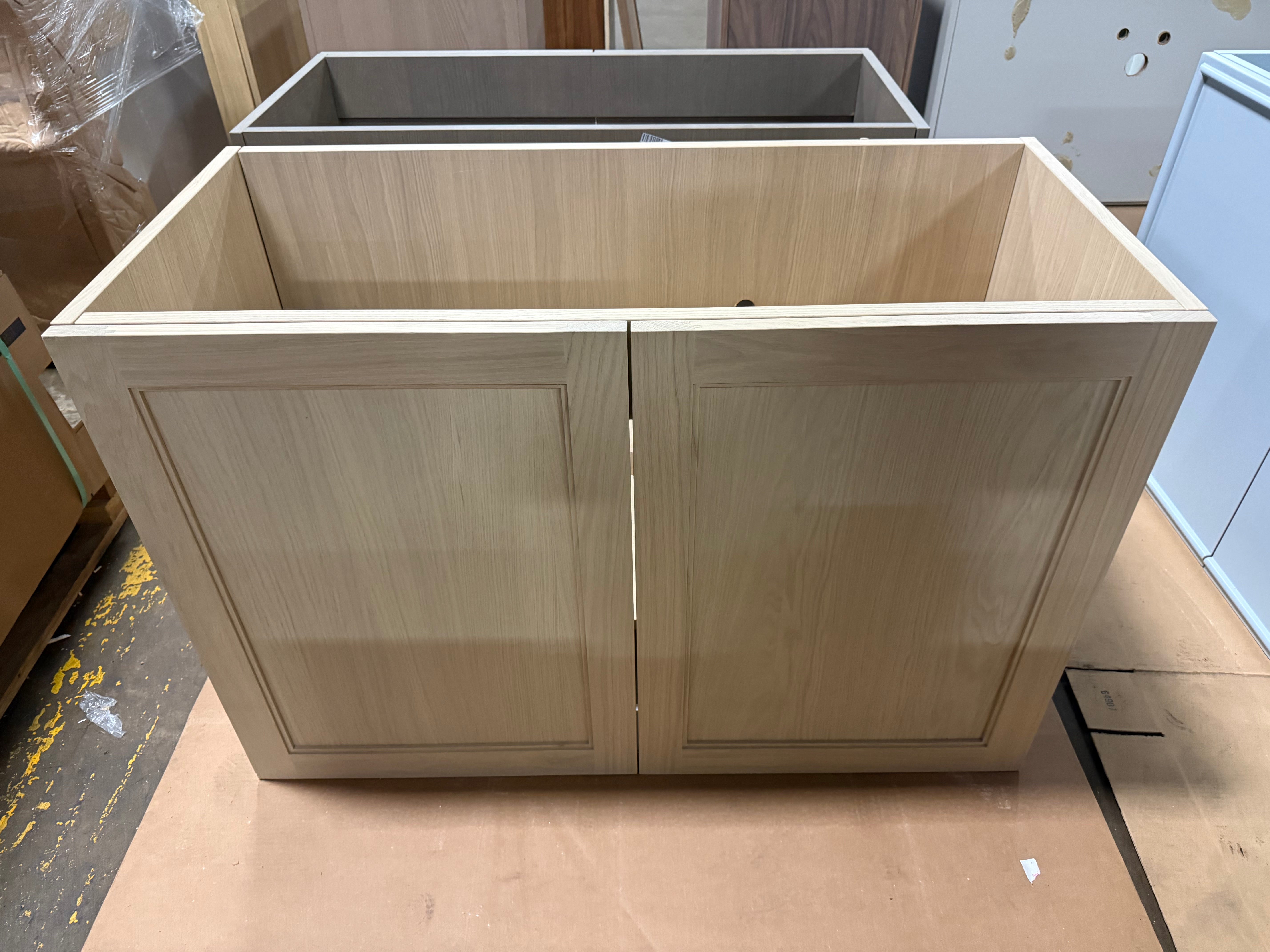 Close up view of the pale white oak wood grain finish and soft close drawer pull detail on the DOCA 47 inch vanity